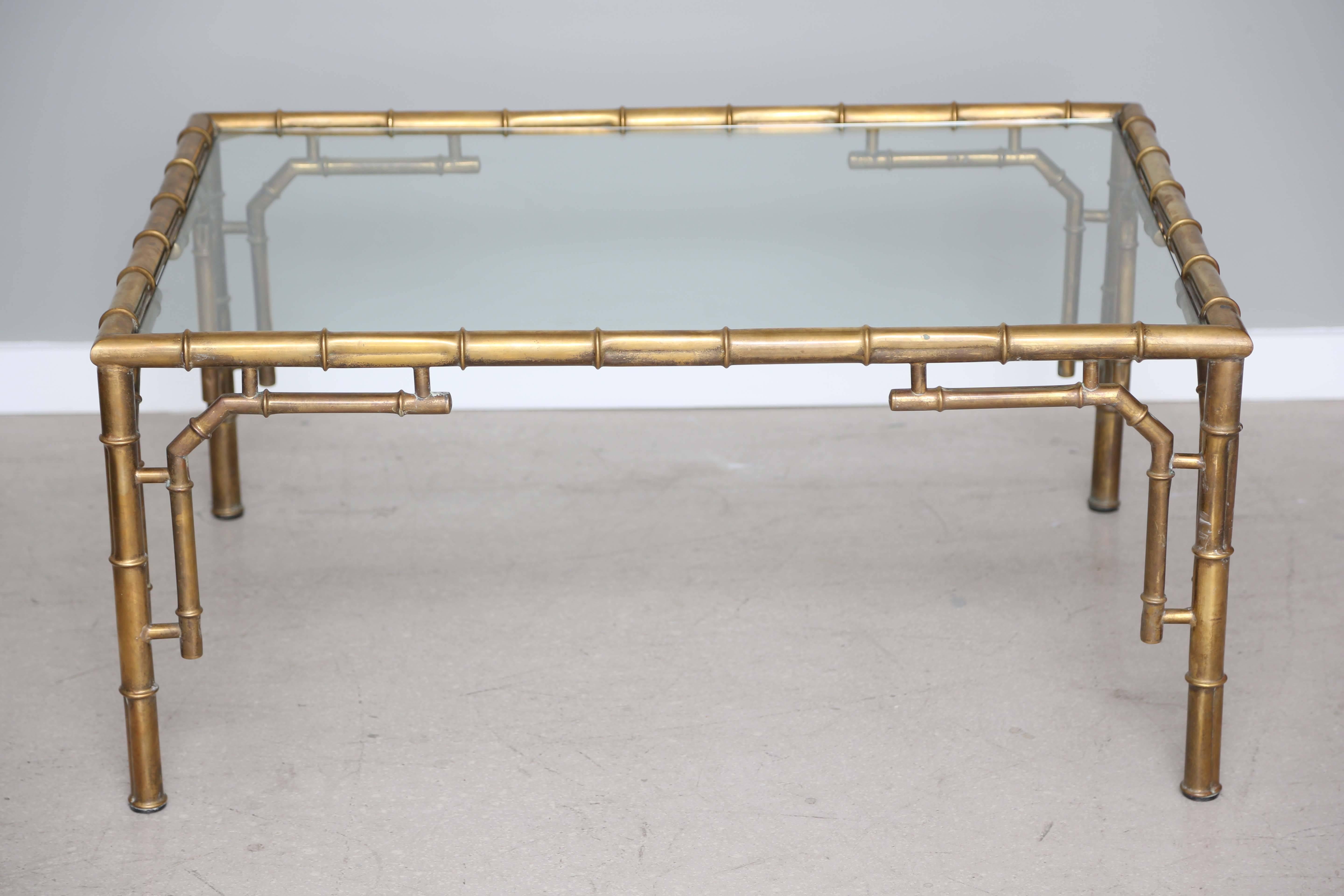 Hollywood Regency brass coffee table with faux bamboo motif.