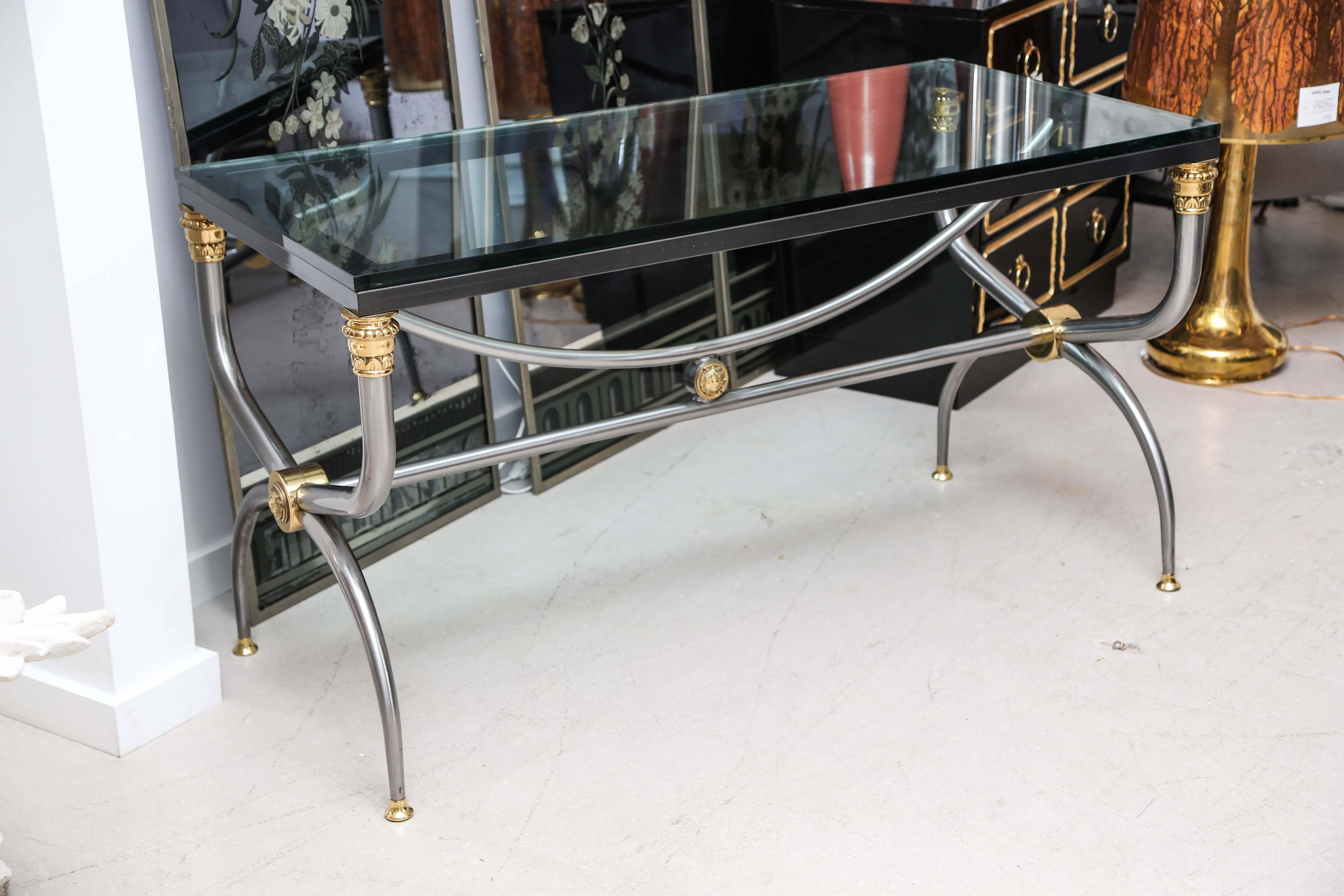 Two-tone Neoclassical style center table or desk with thick glass top.