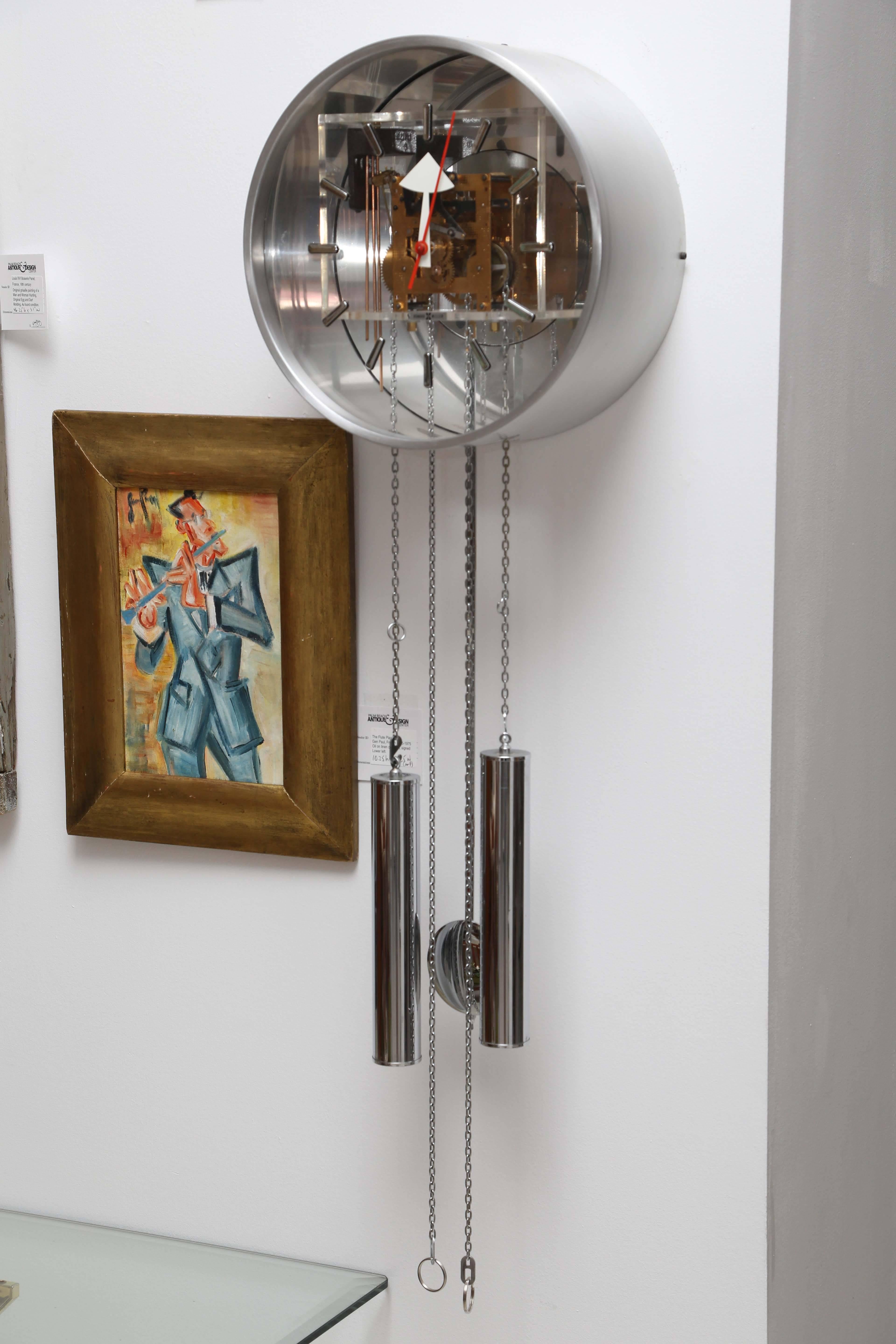 Pendulum wall-mounted clock by George Nelson for Howard Miller made of aluminum, chrome and Lucite. The clock has been professionally serviced in 2016. The face of the clock is 12