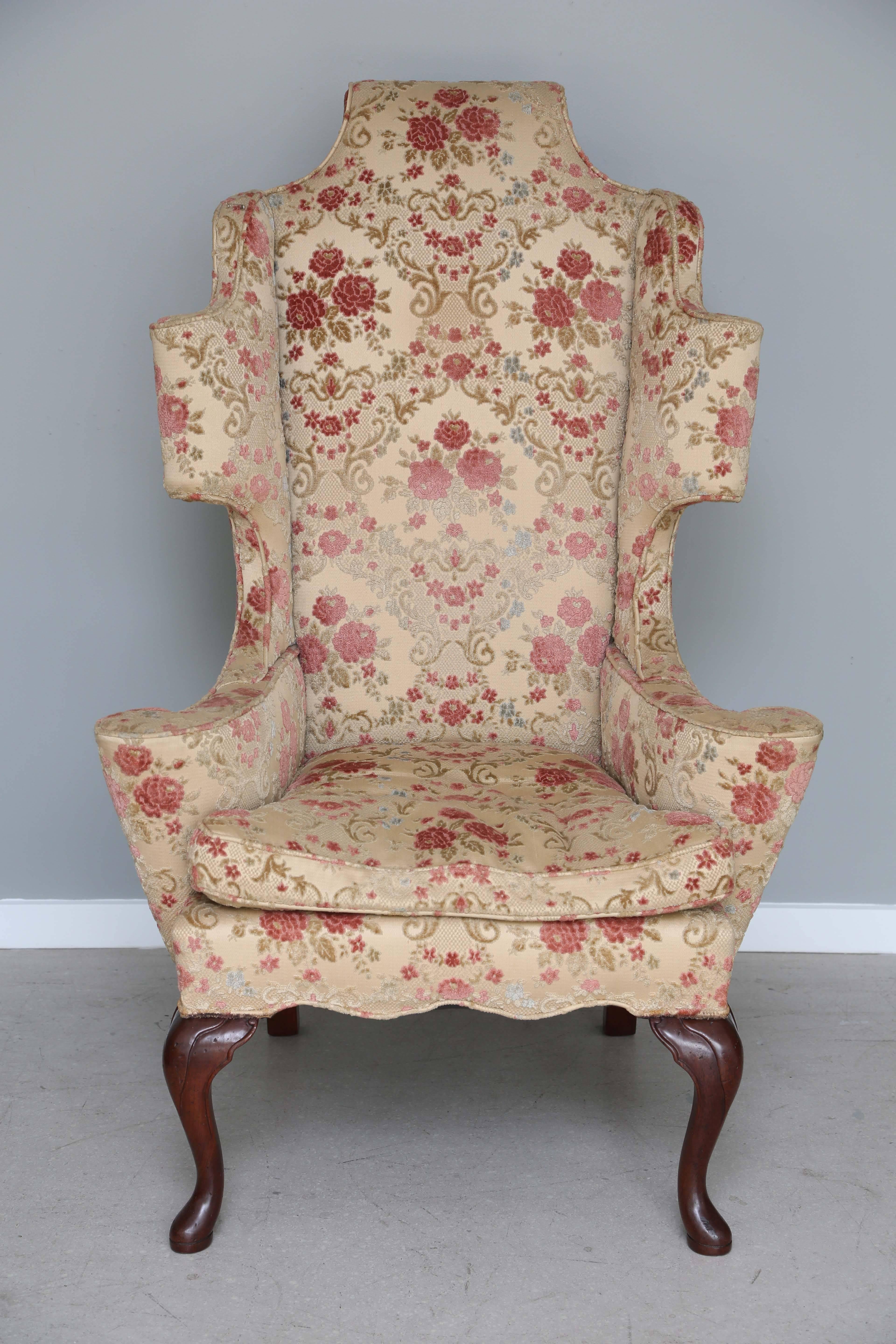 Sculptural Queen Anne style chair with carved Mahogany legs. Dramatic in proportion and attractive from all angles.