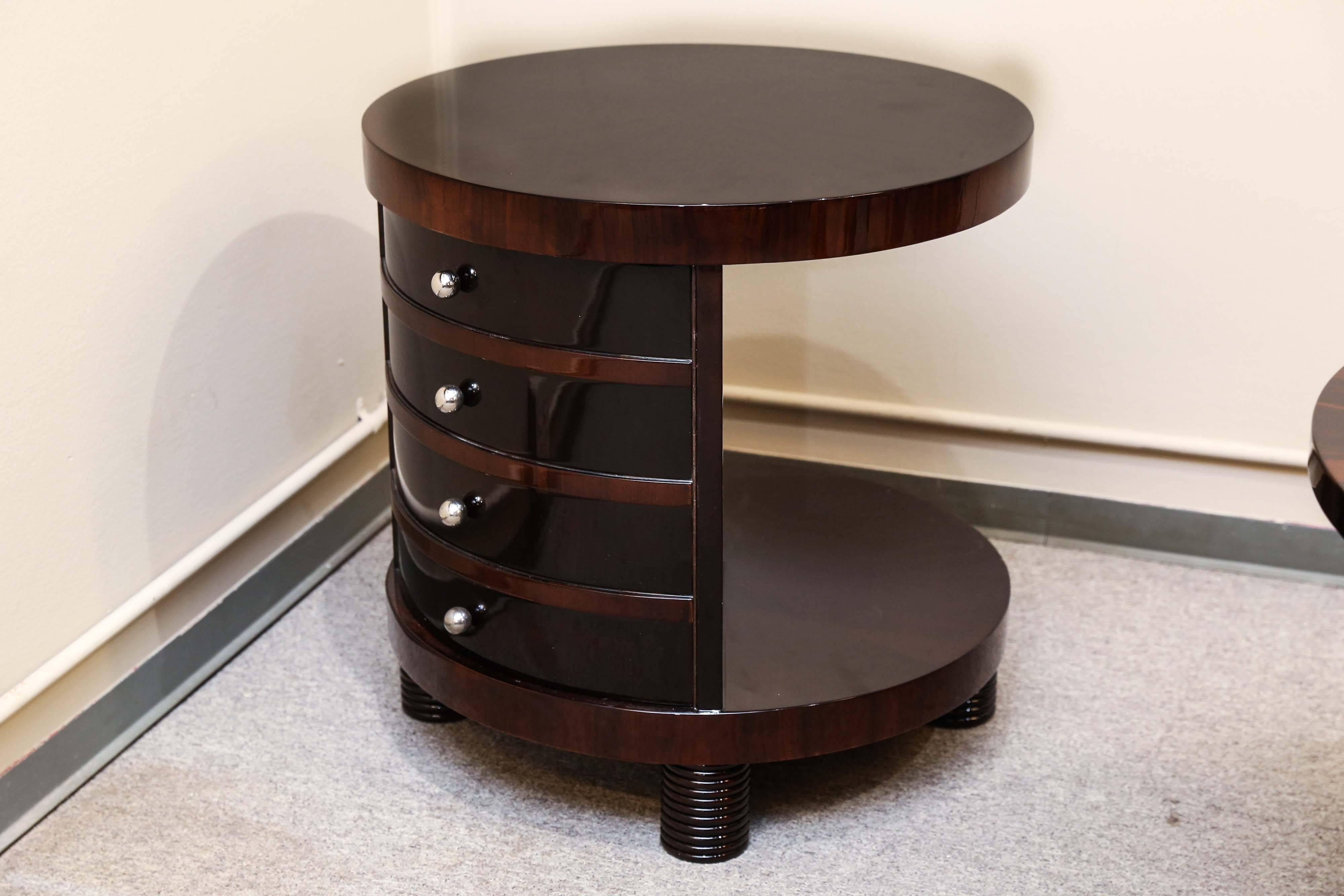 The round top and the bottom of the side table is attached to each other by the four spacious drawers, that are placed one on top of each other. Each of the drawers have small round handle. The bottom panel is elevated by four “cylinder shaped”