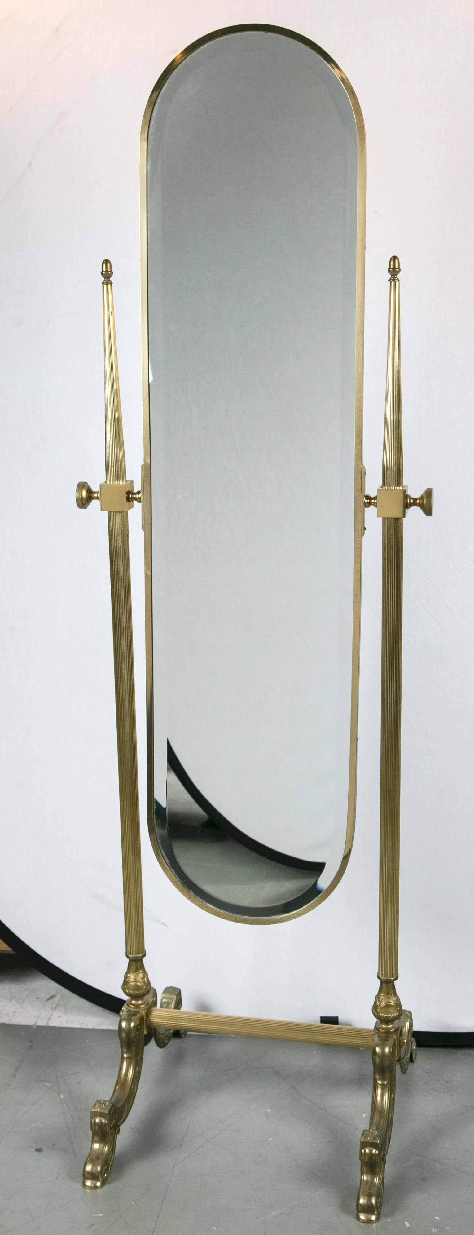 A unique French Parisian standing mirror with its legs ending in dolphin heads and original bevelled mirror intact.