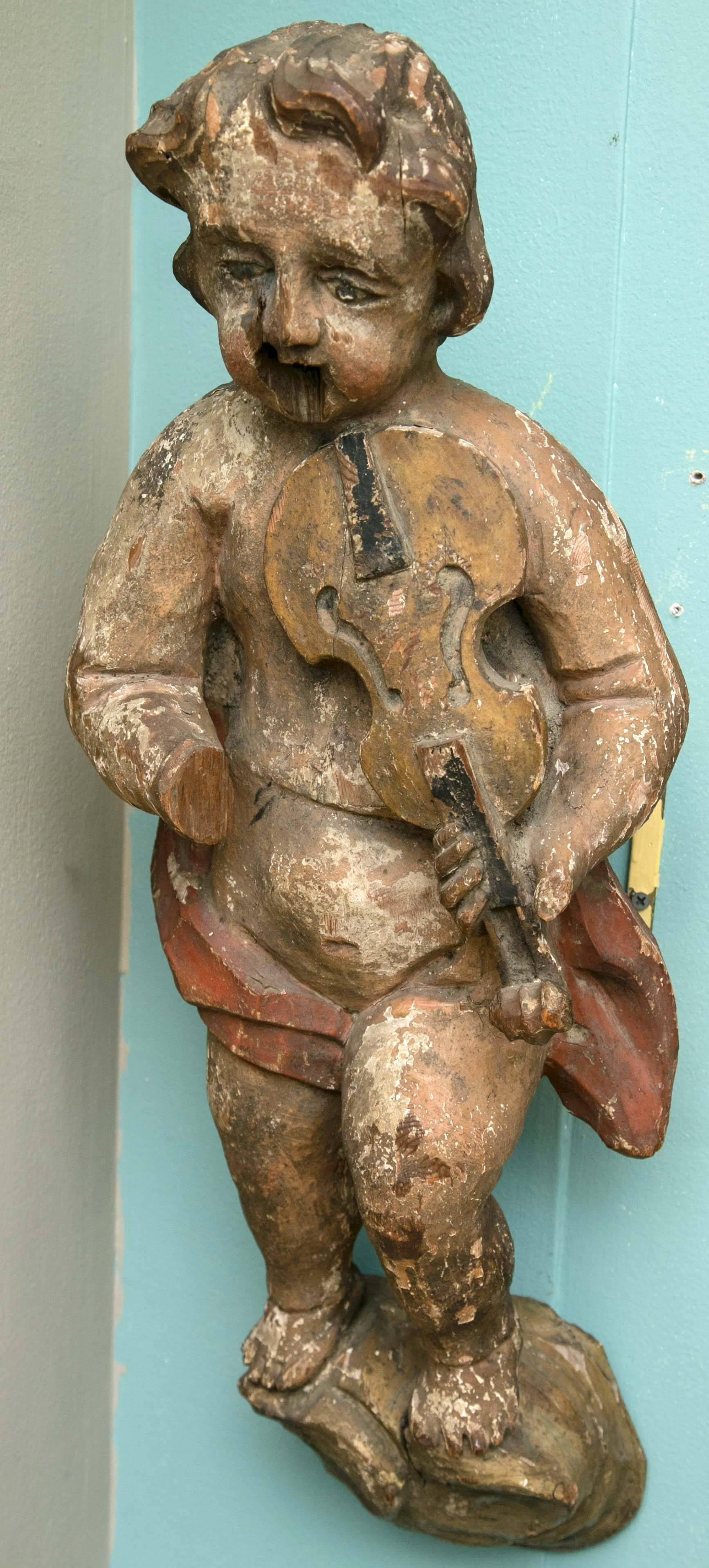 Charming 18th century Italian putti with violin original paint hanging device installed.