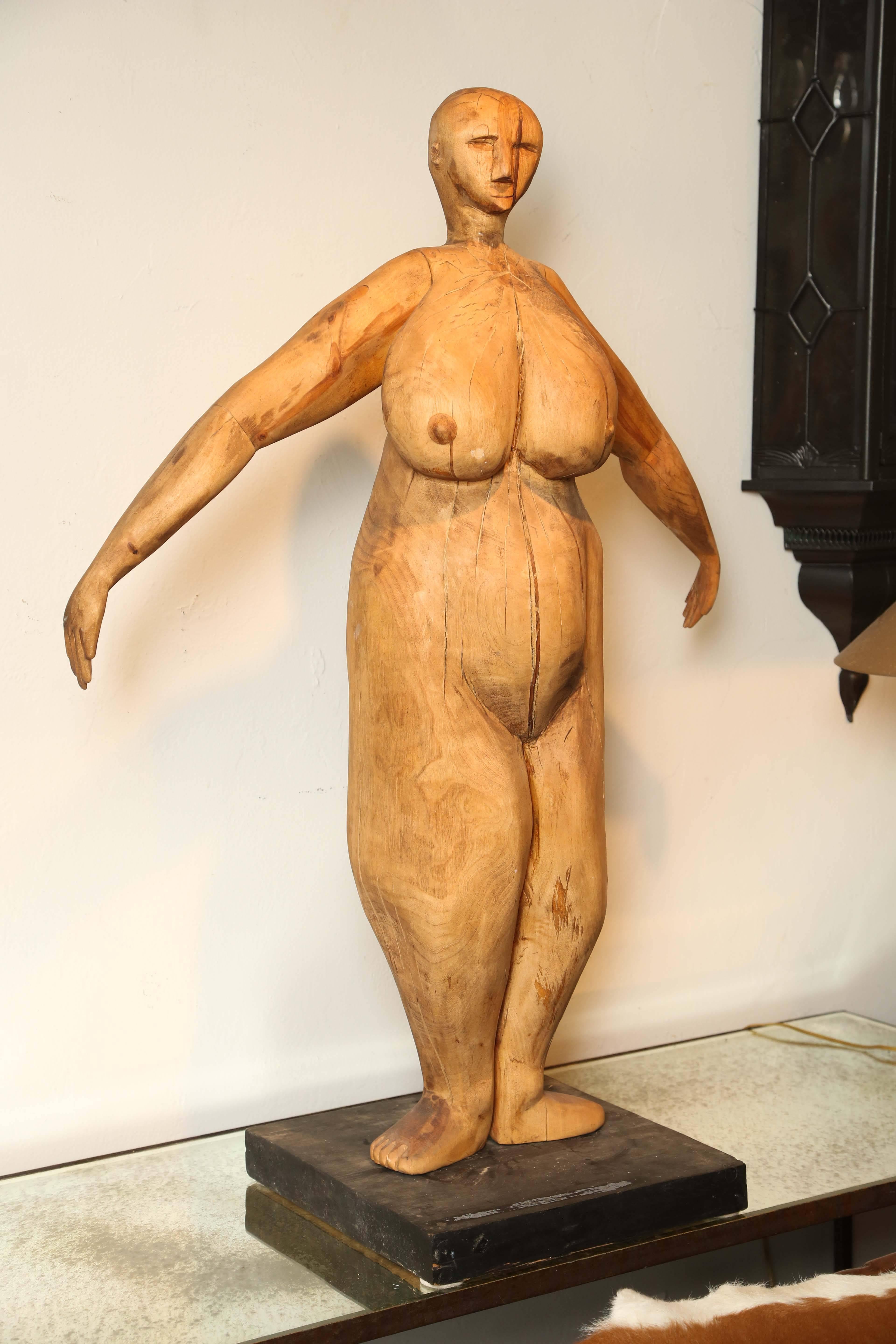 Large wood sculpture of a female in the Cubist style.
