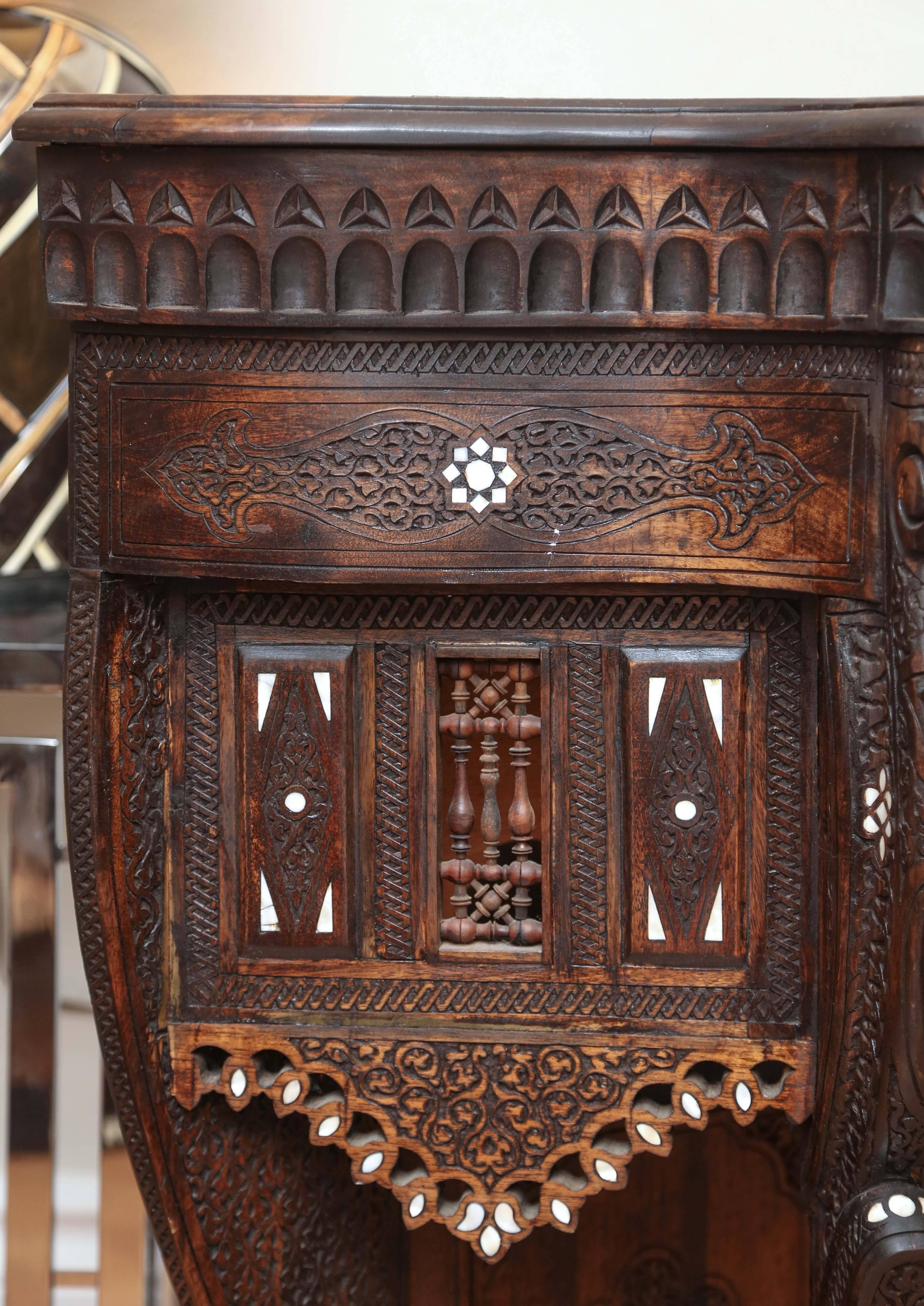 Syrian carved wood console with delicate mother-of-pearl inlays. The top is hinged to open and reveals a storage compartment.