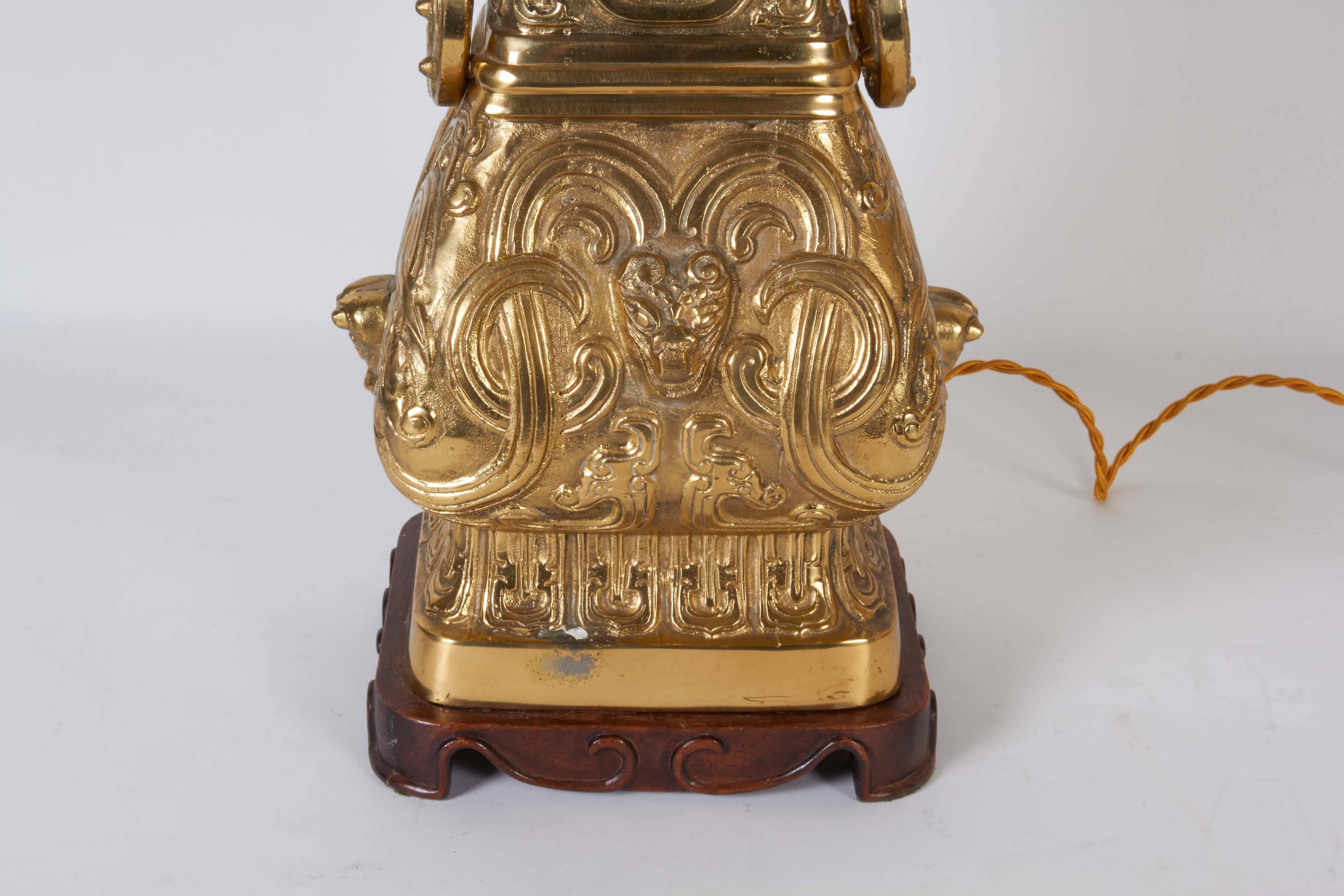 Brass Pair of Archaic Chinese Vase Form Lamps in the Manner of James Mont