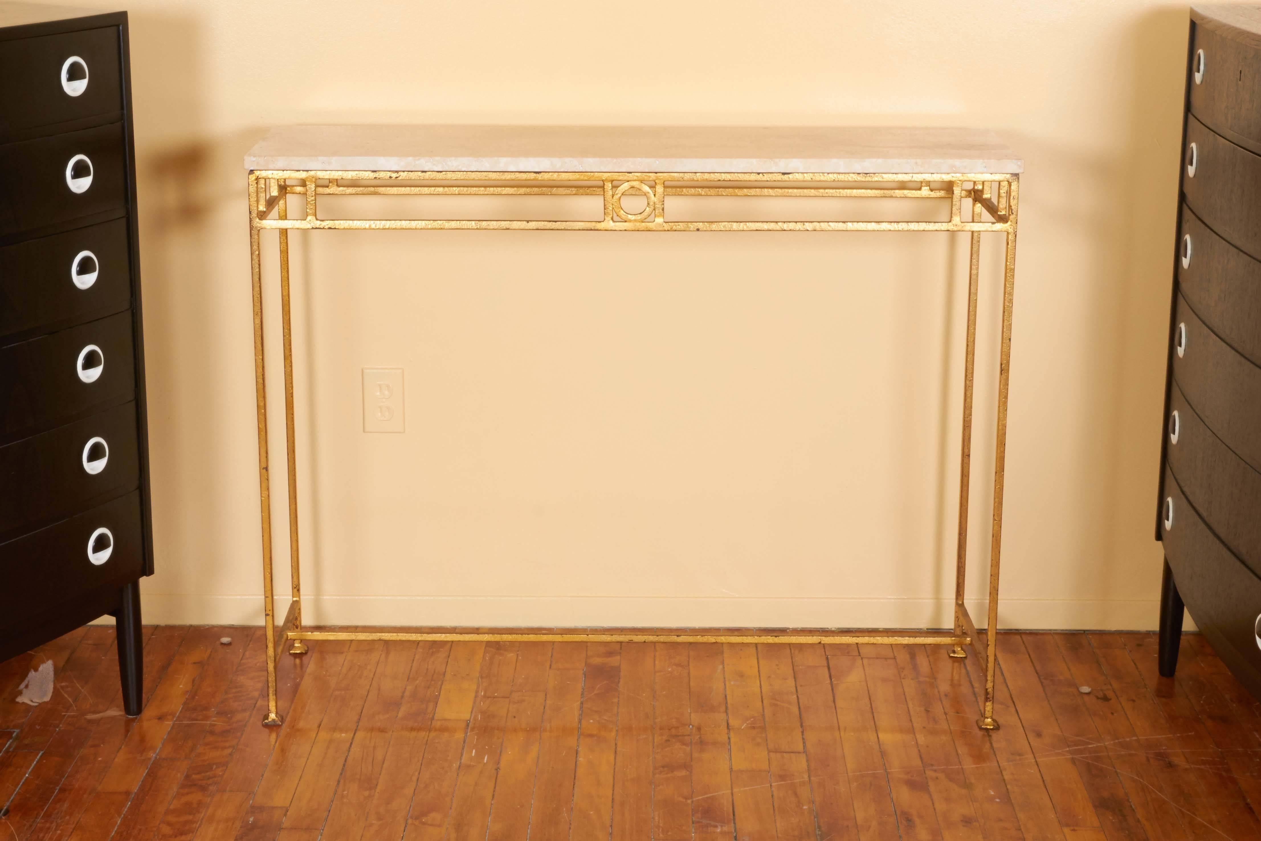 A French console table, manufactured circa 1950s, with travertine top on linear metal base with gilt finish, detailed with geometric forms. Very good vintage condition, wear and minor loss of finish consistent with age and use.

10797