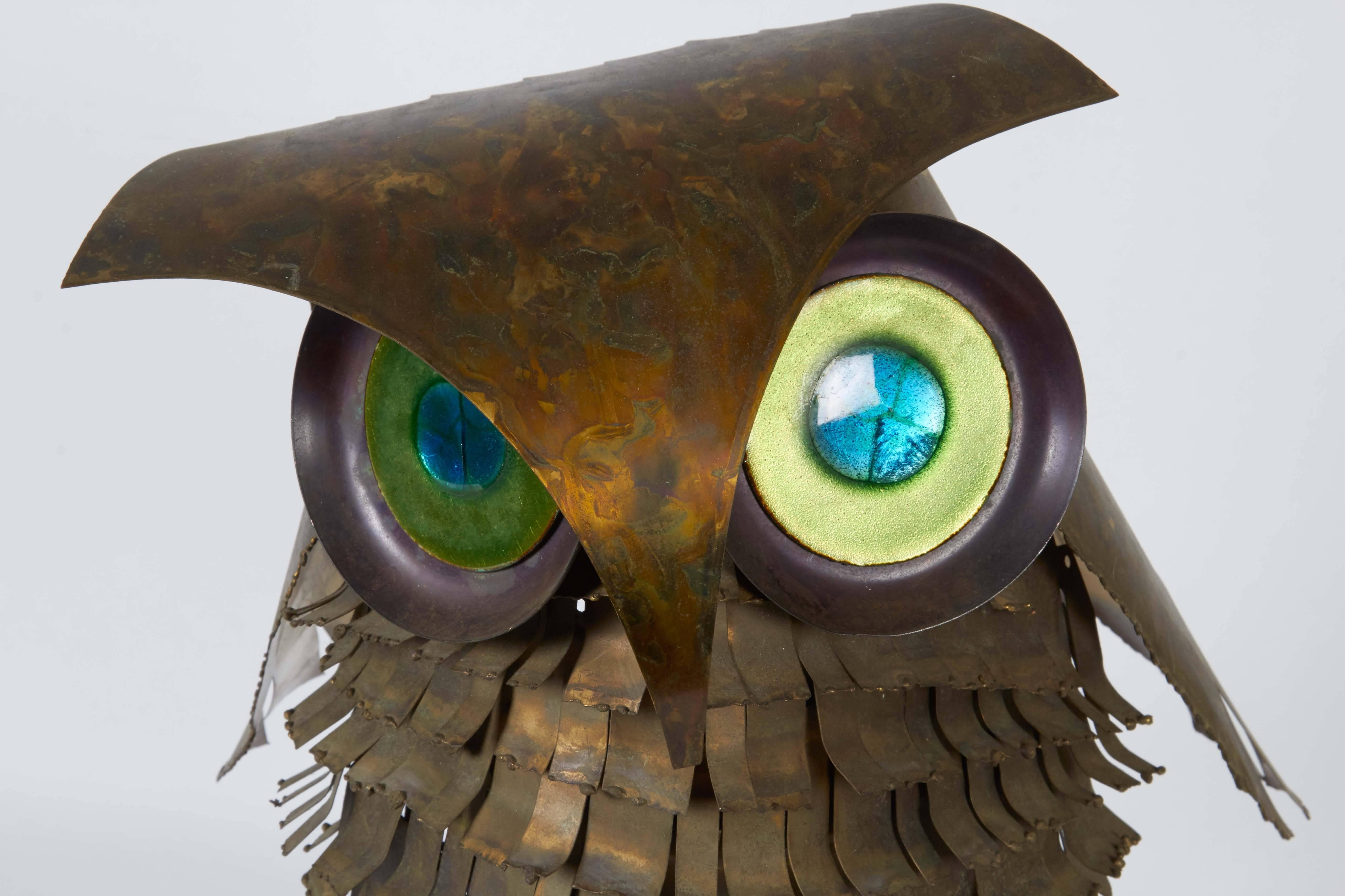 A Brutalist sculpture of an owl by Curtis Jere, produced 1968, with stylized feathers and crest crafted of patinated metals, mounted on a black lacquered wood base. Markings include signature and date ['68] to a small plaque to base. Very good
