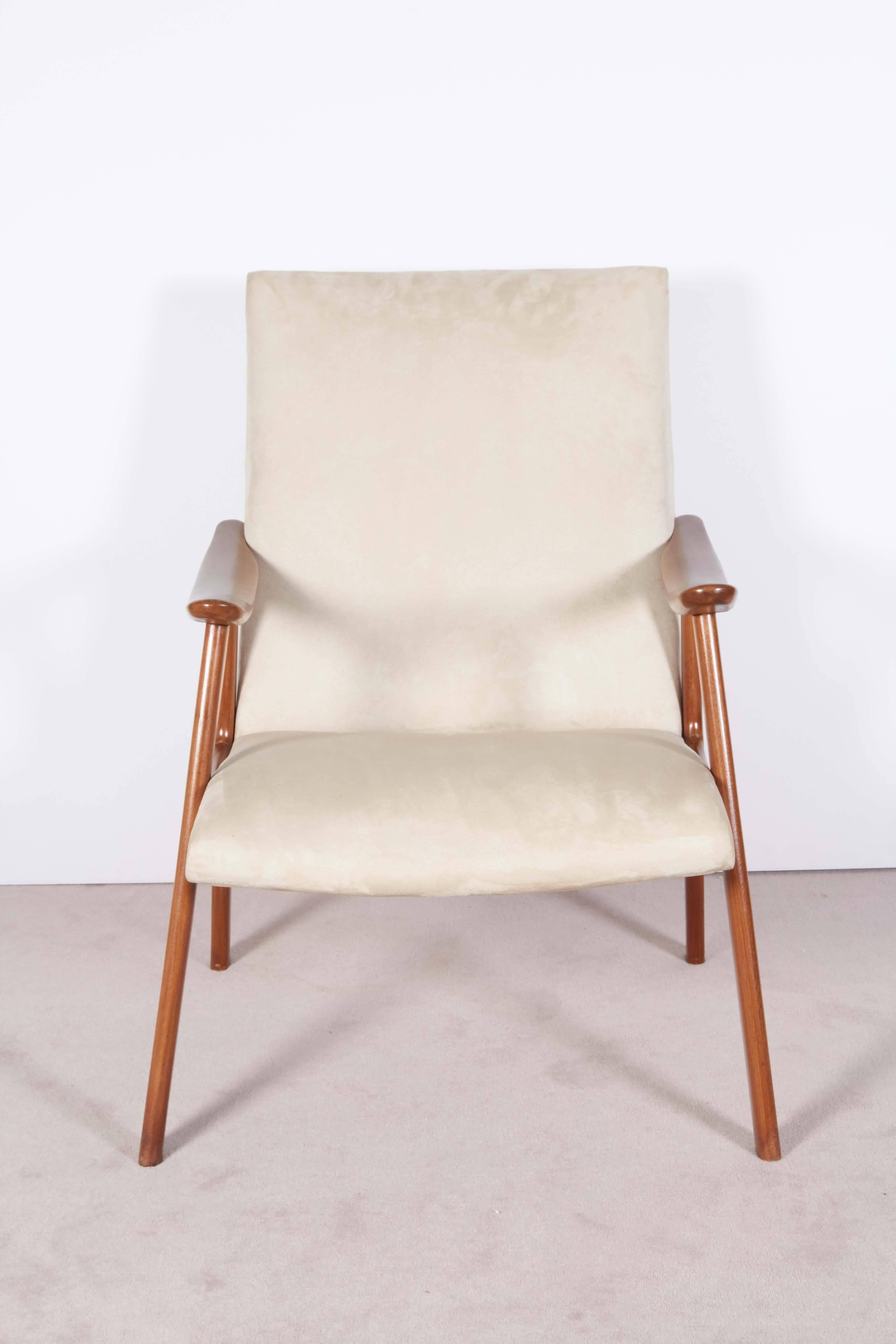 A vintage Scandinavian modern lounge armchair, manufactured in Denmark, curved seat and back entirely upholstered in ivory toned faux suede, on 'A' frames as base. Excellent condition, consistent with age and use. 

10869