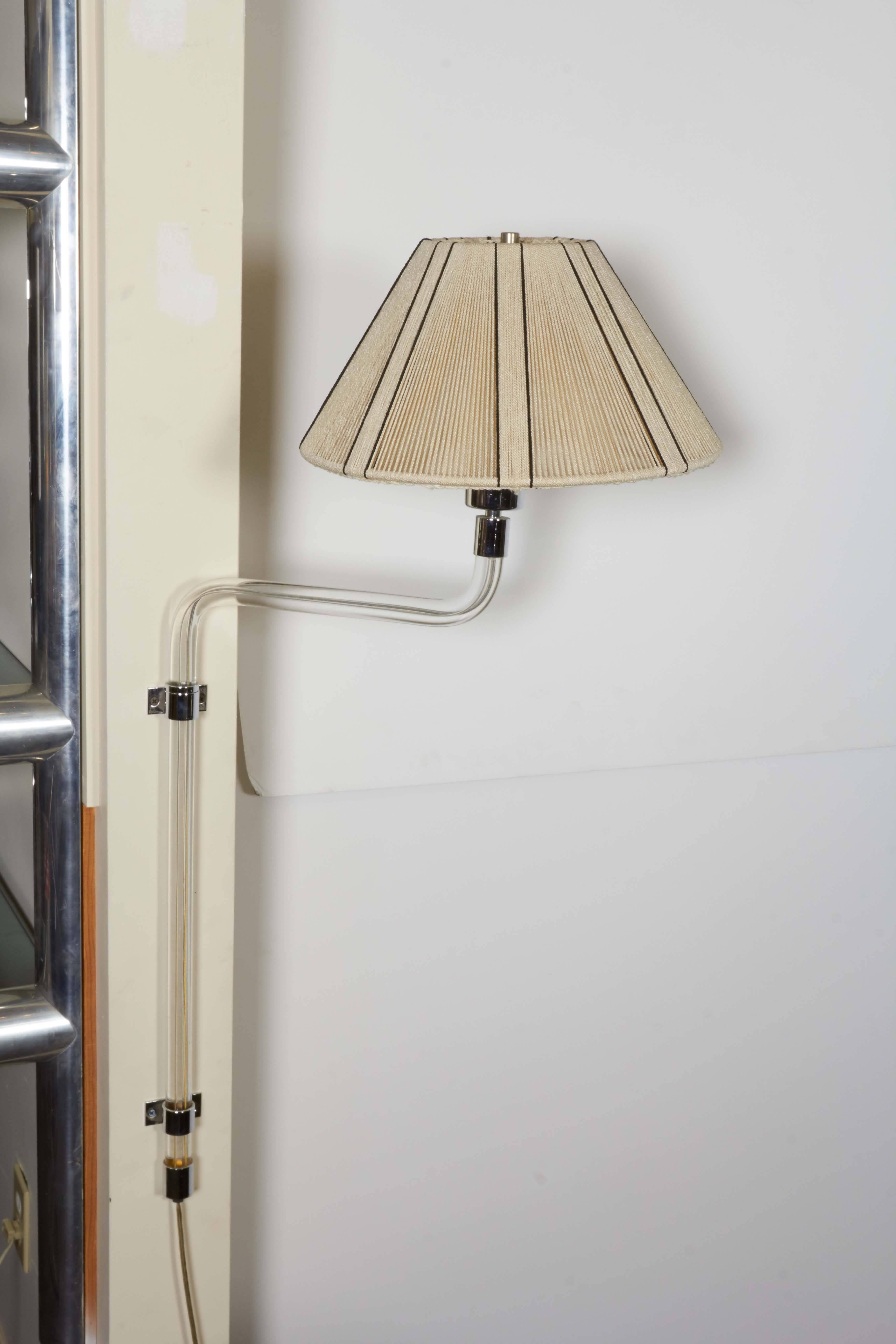 A swing wall light by designer Peter Hamburger, manufactured circa 1960s-1970s by Knoll, the curved stem comprised of Lucite, accented in chrome, including original string shade. Excellent vintage condition, consistent with age and use.

10819