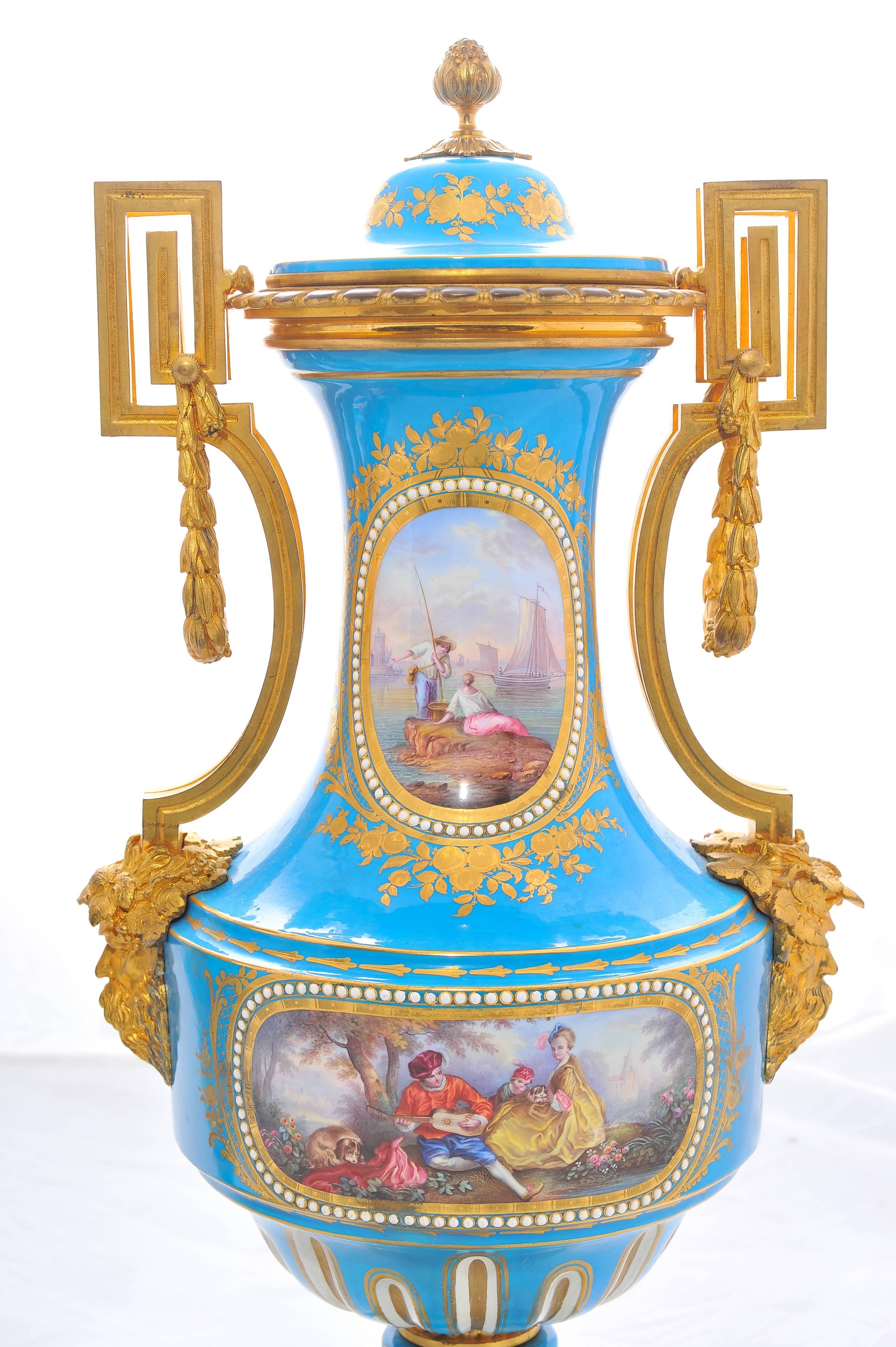 A very good quality pair of 19th century lidded 'Sevres' porcelain lidded vases. Each having wonderful gilded ormolu mounts. Classical hand-painted scenes set on a Turquoise back ground with golf leaf and raised on ormolu bases.