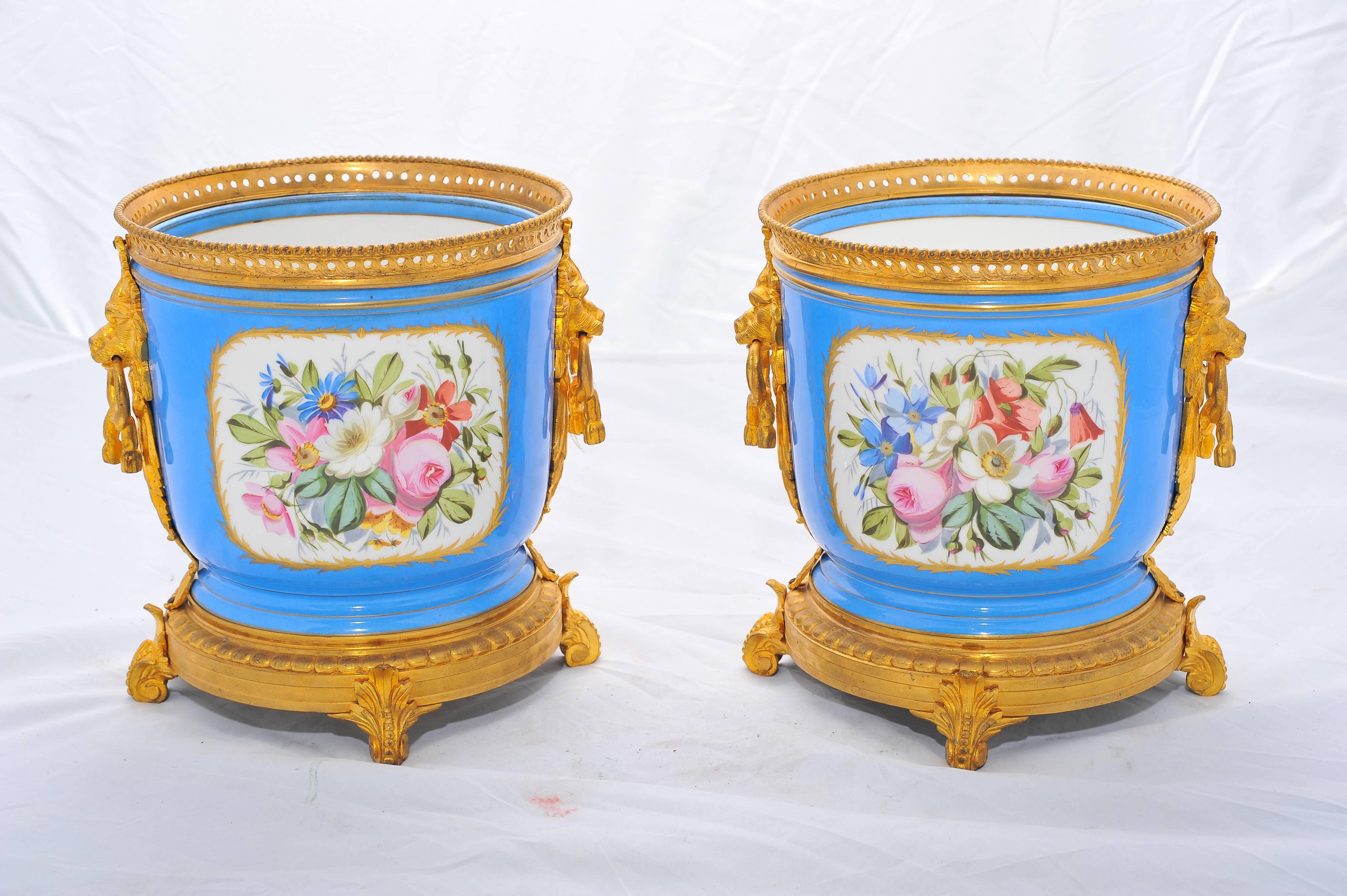 A good quality pair of French 'Sevres' porcelain jardinières, having classical romantic scenes to the front and floral scenes to the reverse.