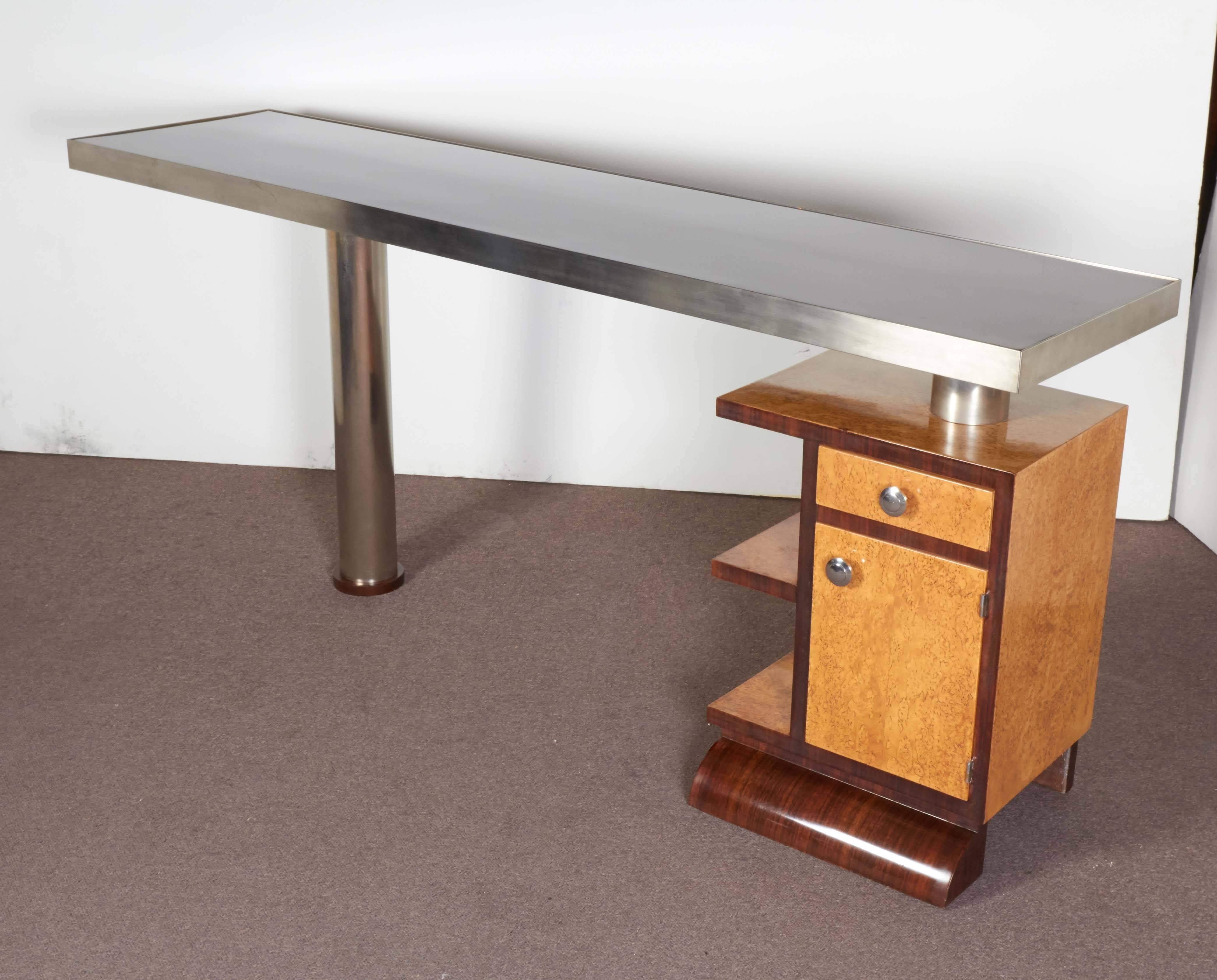 French Art Deco slim and streamline unusual desk in two tone wood with side storage compartment, polished nickeled bronze banded surround and matching pole support.
The side structure can be turned around 180 degrees and therefore placed either on