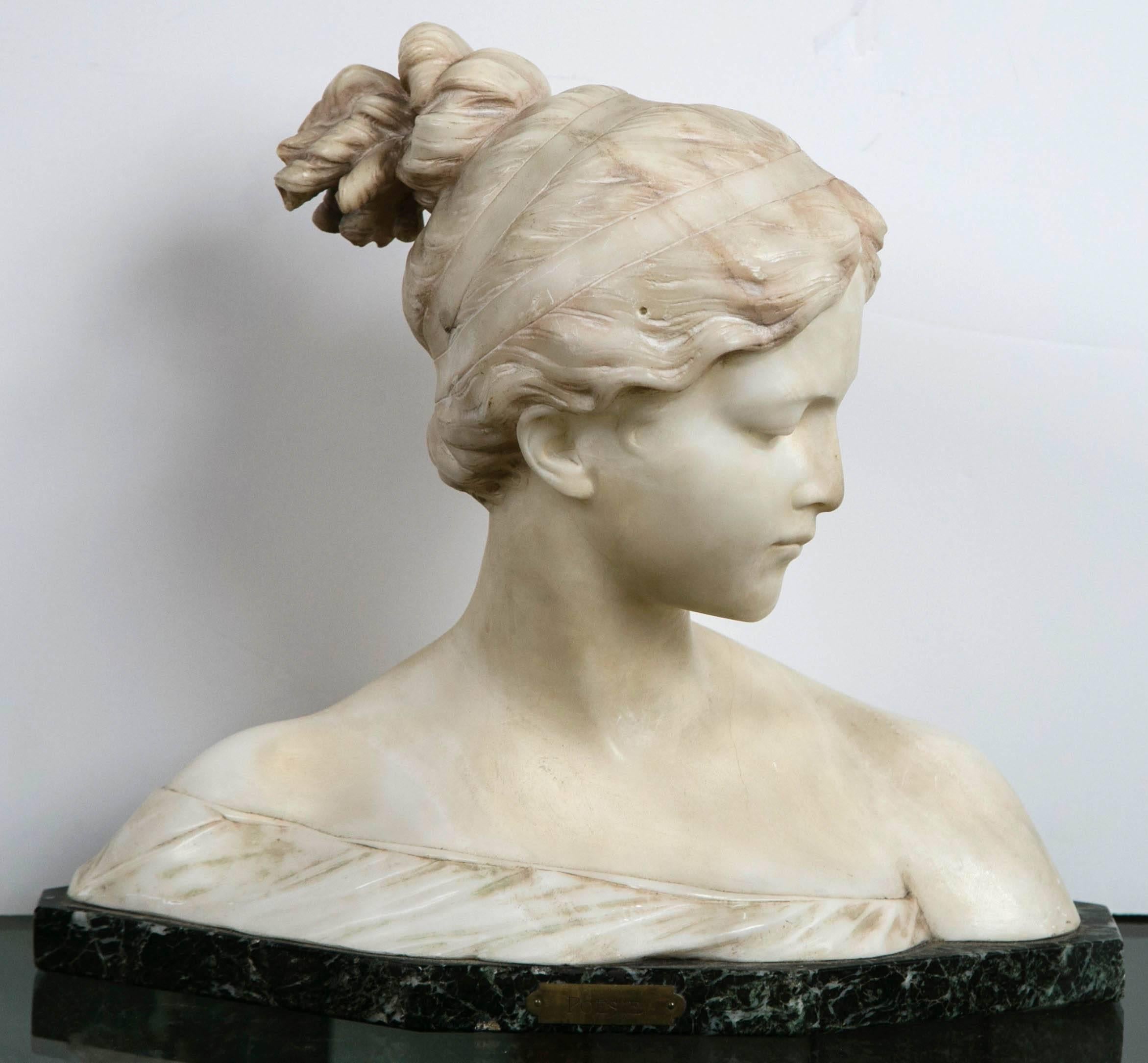 This marble bust of a lovely young female has a incised signature on back of the left shoulder. It appears to read Prof. Ganelli with an illegible location below it.

Her hair tied up atop her head in masterful marble carving. The slight look of a