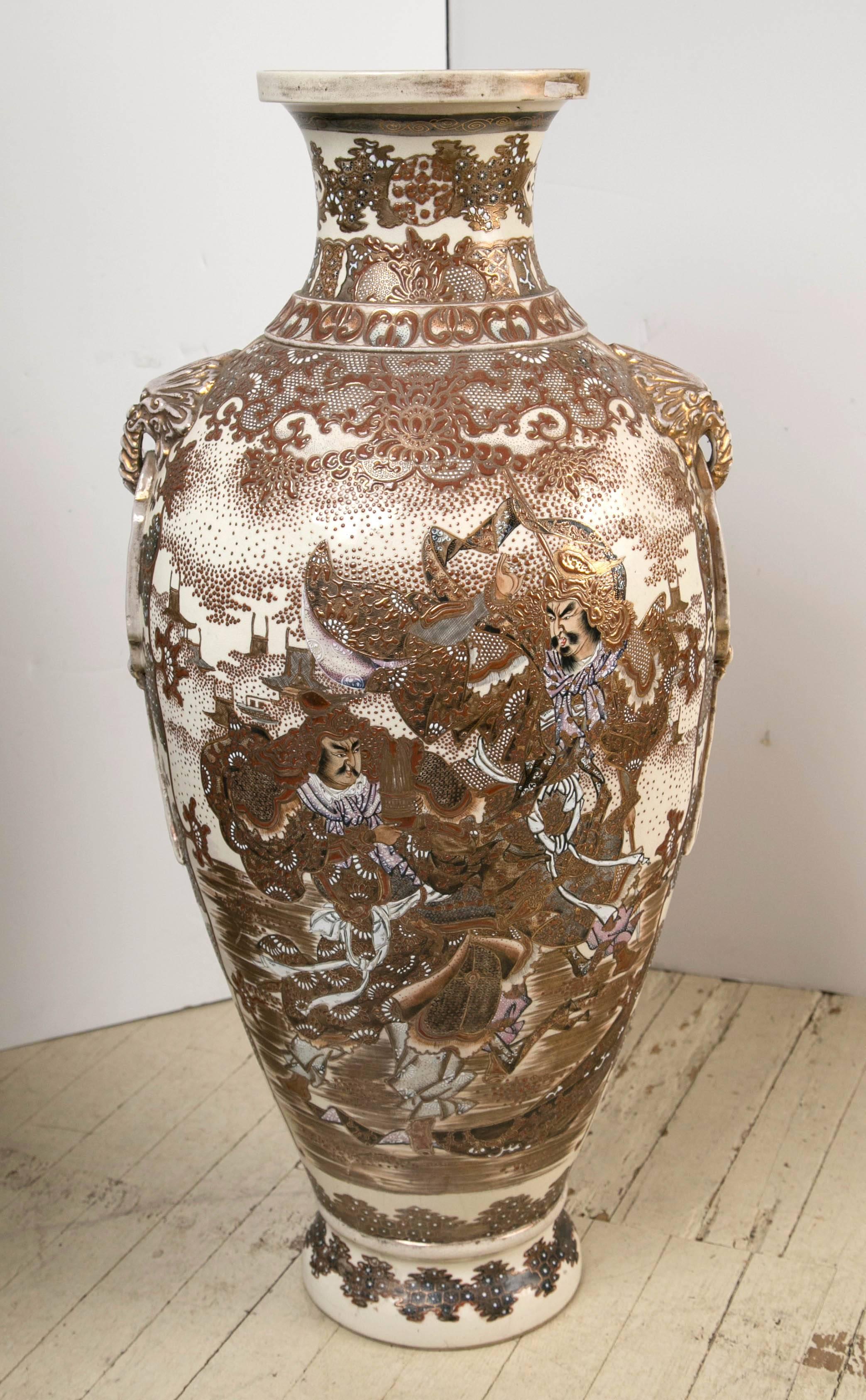 These antique Satsuma vases have an off-white ground to which hand painting and gilding have been applied. Extremely fine decorations of florals, vines, leaves and what appear to be war lords or samurai, one of whom seems to be playing a flute.