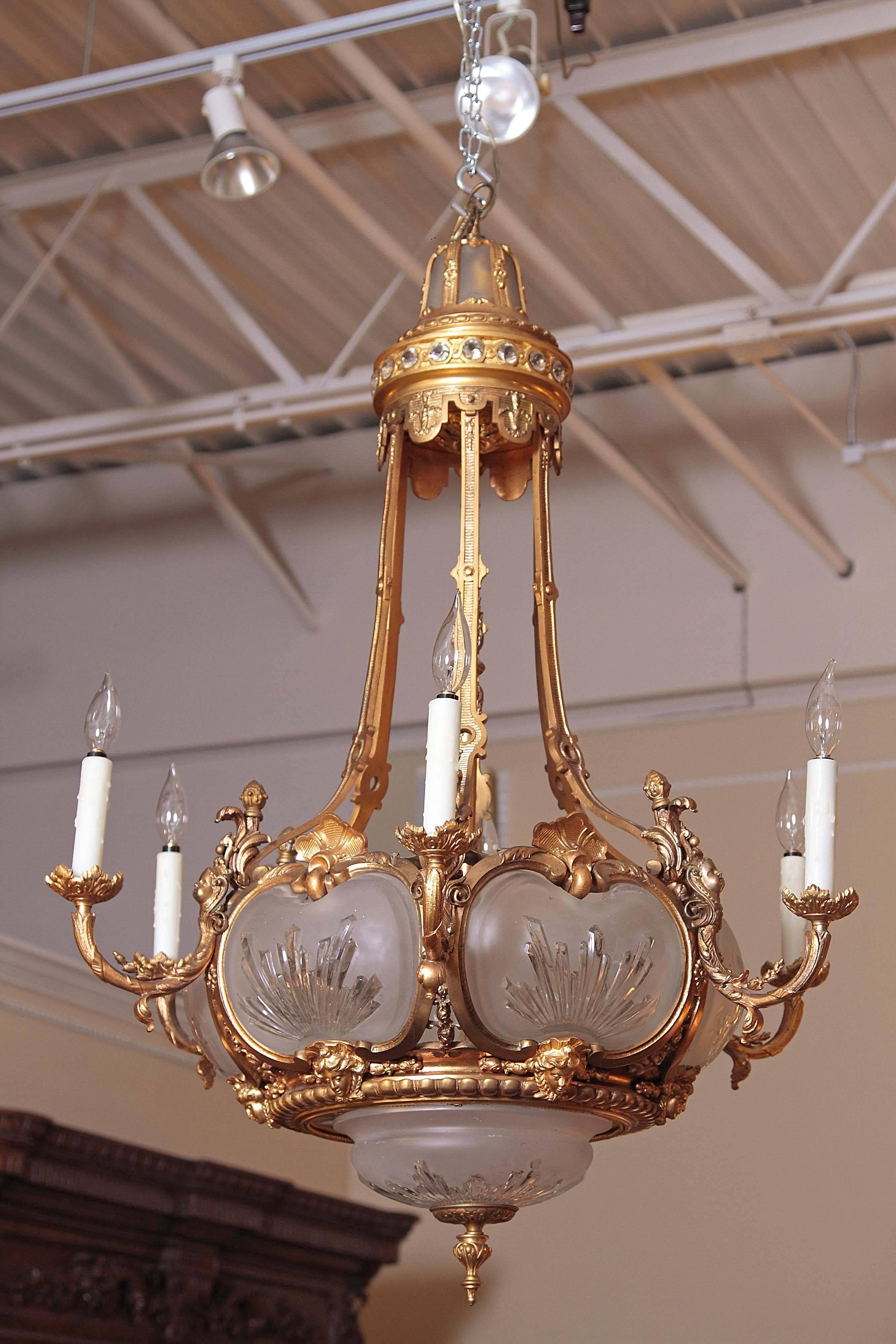 19th century French Louis Philippe gilt bronze finely cast chandelier. Frosted crystal bowl and sides. Hand etched. Gilt bronze cherub heads and female heads.