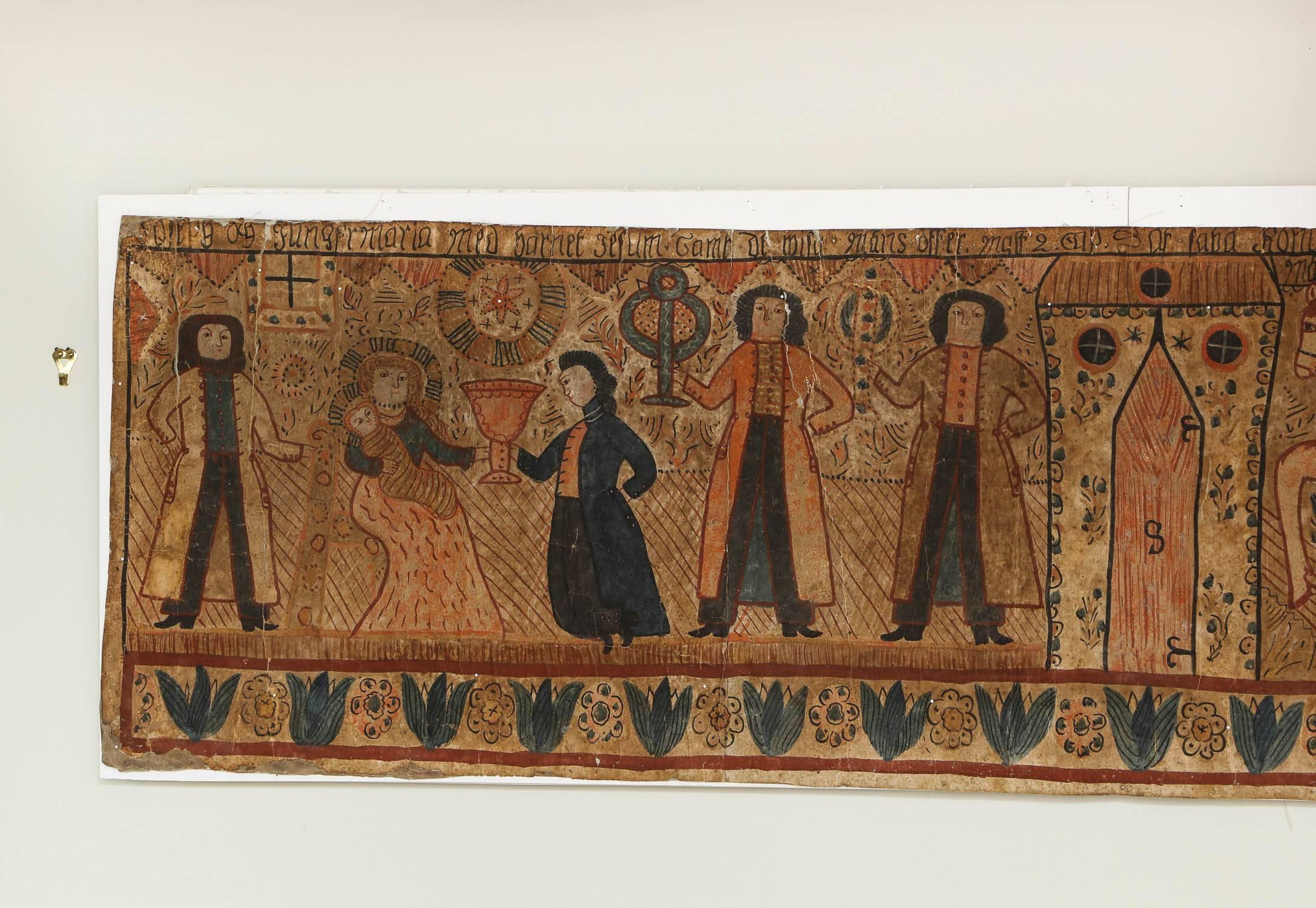 A folk art wall panel hand painted by an itinerant artist in Sweden in 1837 (dated), depicting the nativity, with the three kings on horseback paying homage to Mary seated on a throne with baby Jesus in her arms, with other figures offering gifts,