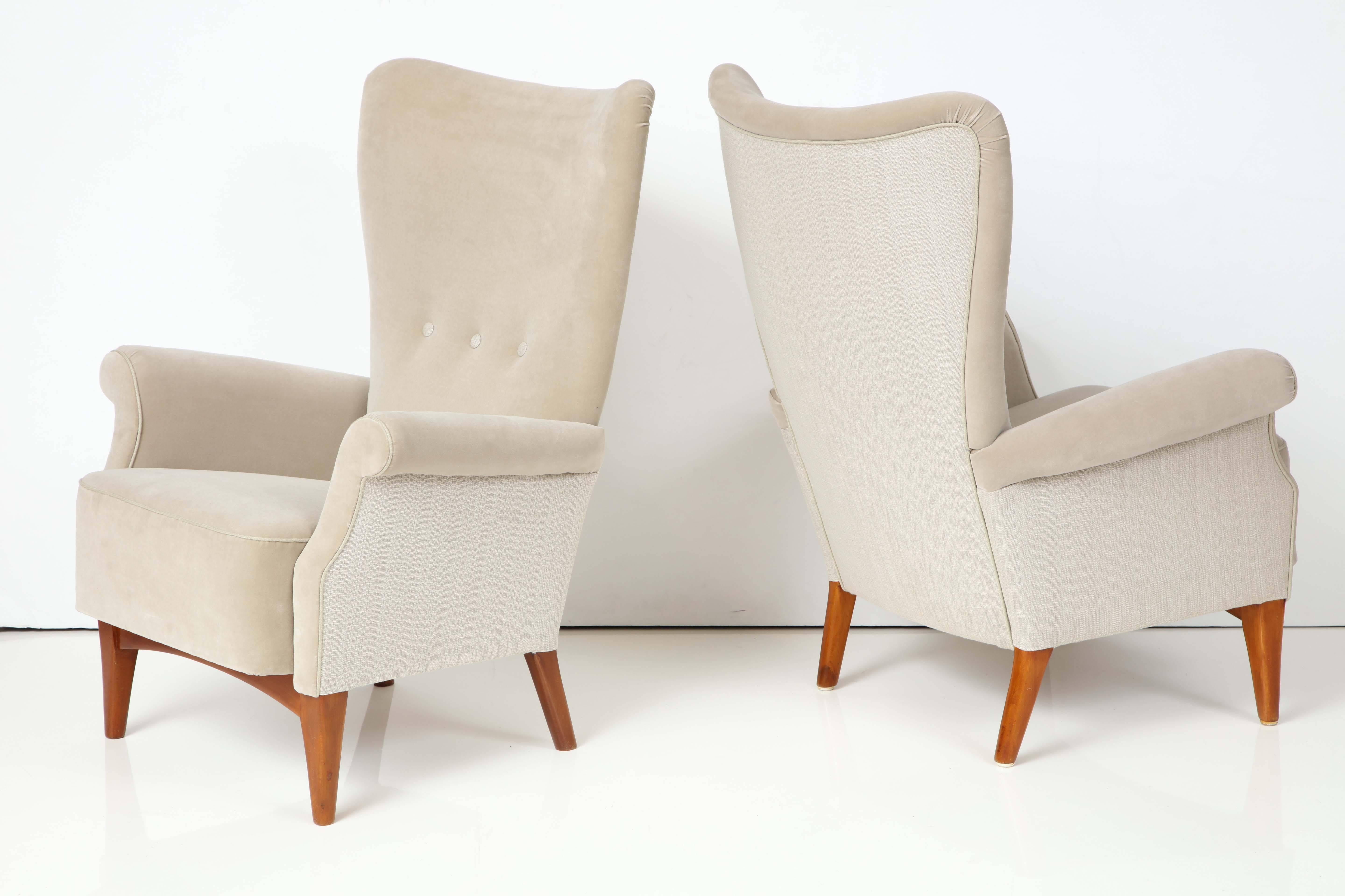 A pair of Danish teak and upholstered highback armchairs, Produced by Fritz Hansen, circa 1940s. Stamped. 8020 series. This model series was design to be fully disassembled without the need for one tool. New two tone upholstery. Very stylish and