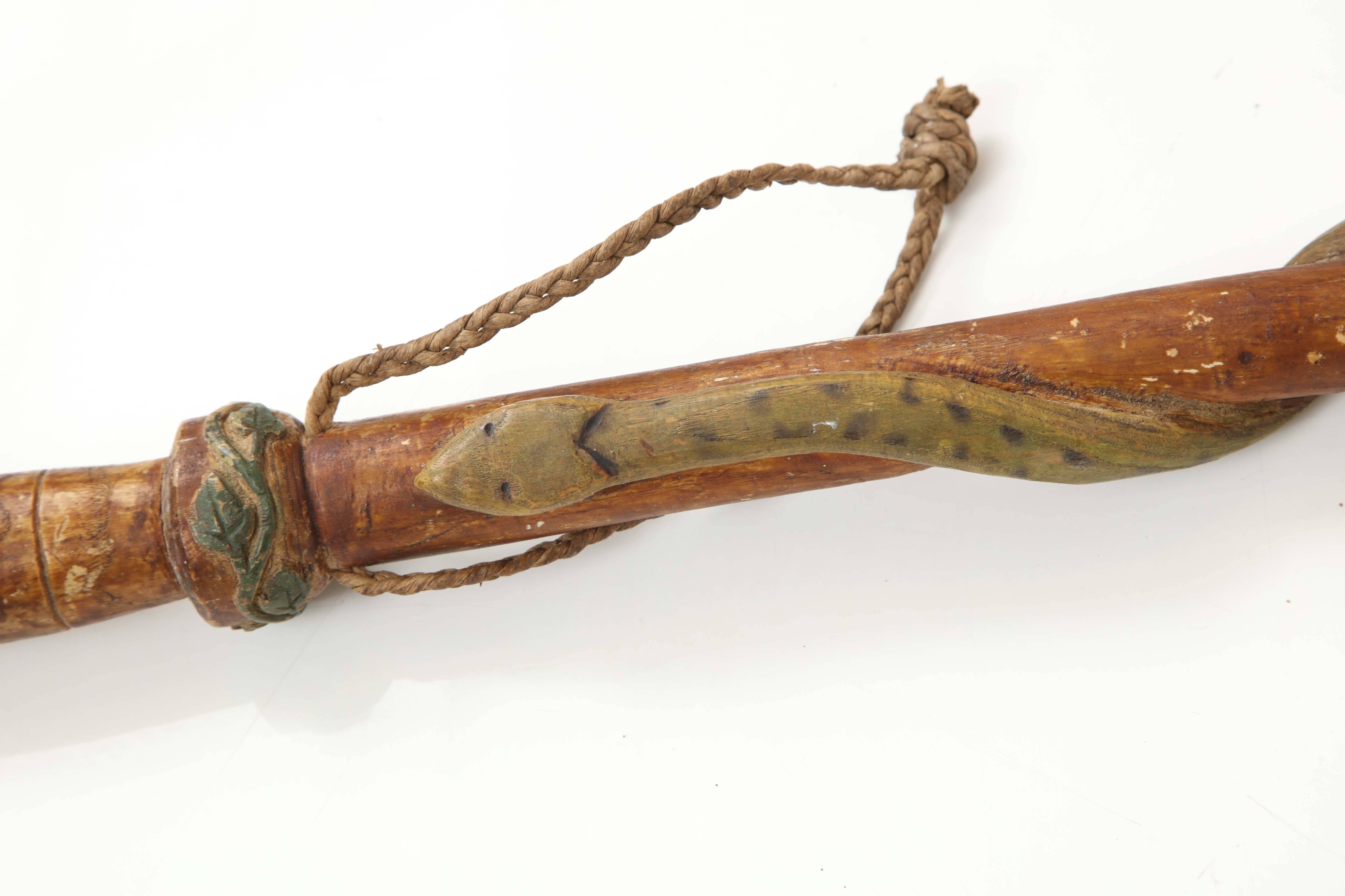 A French carved and painted walking stick, circa 1942, with an entwined carved serpent. Braided leather strap. Signed - P. Fouasseau, Classe 1942. 

Original surface.