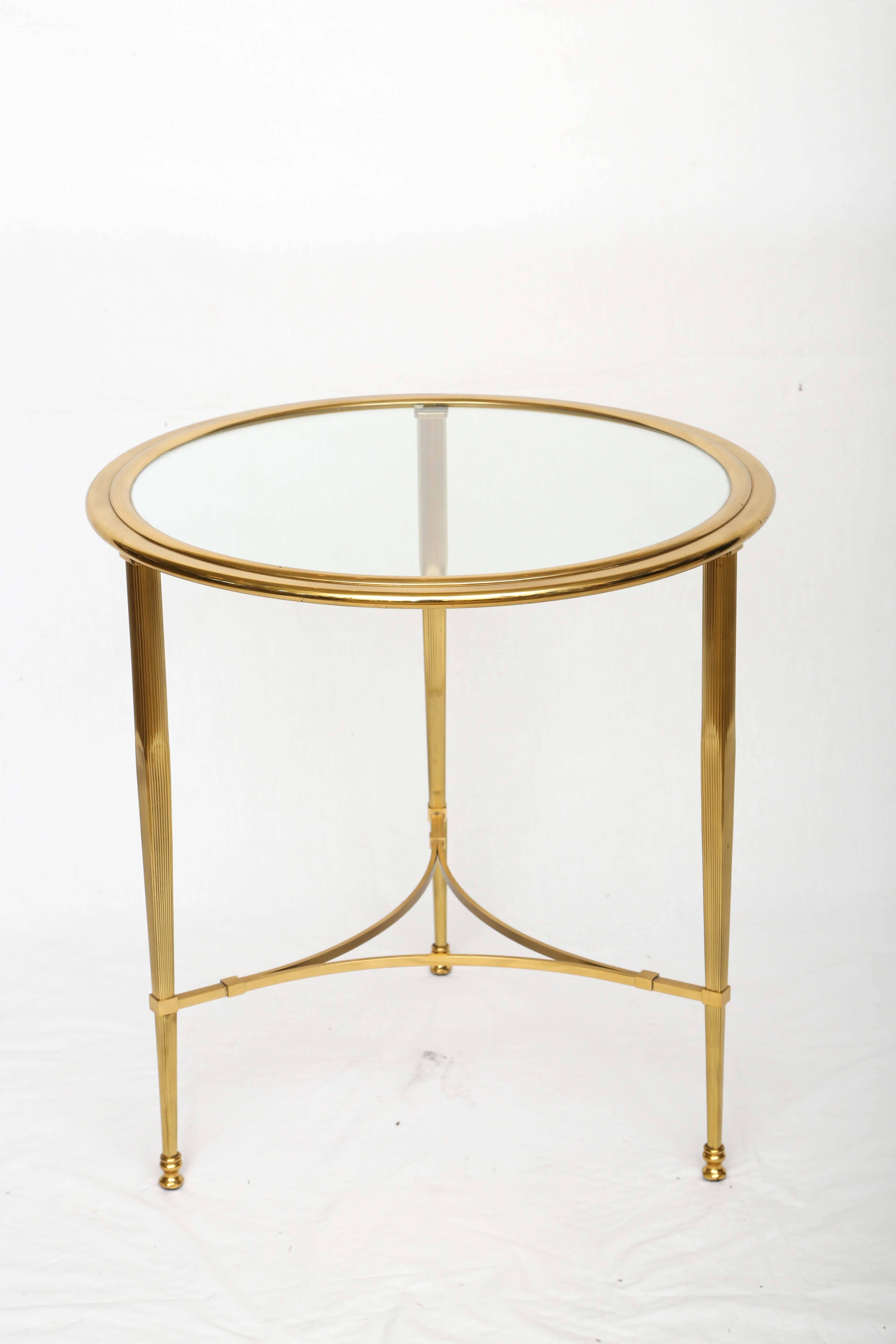 Hollywood Regency bronze glass top side table with a very decorative base.
The glass is inserted into the bronze rim.