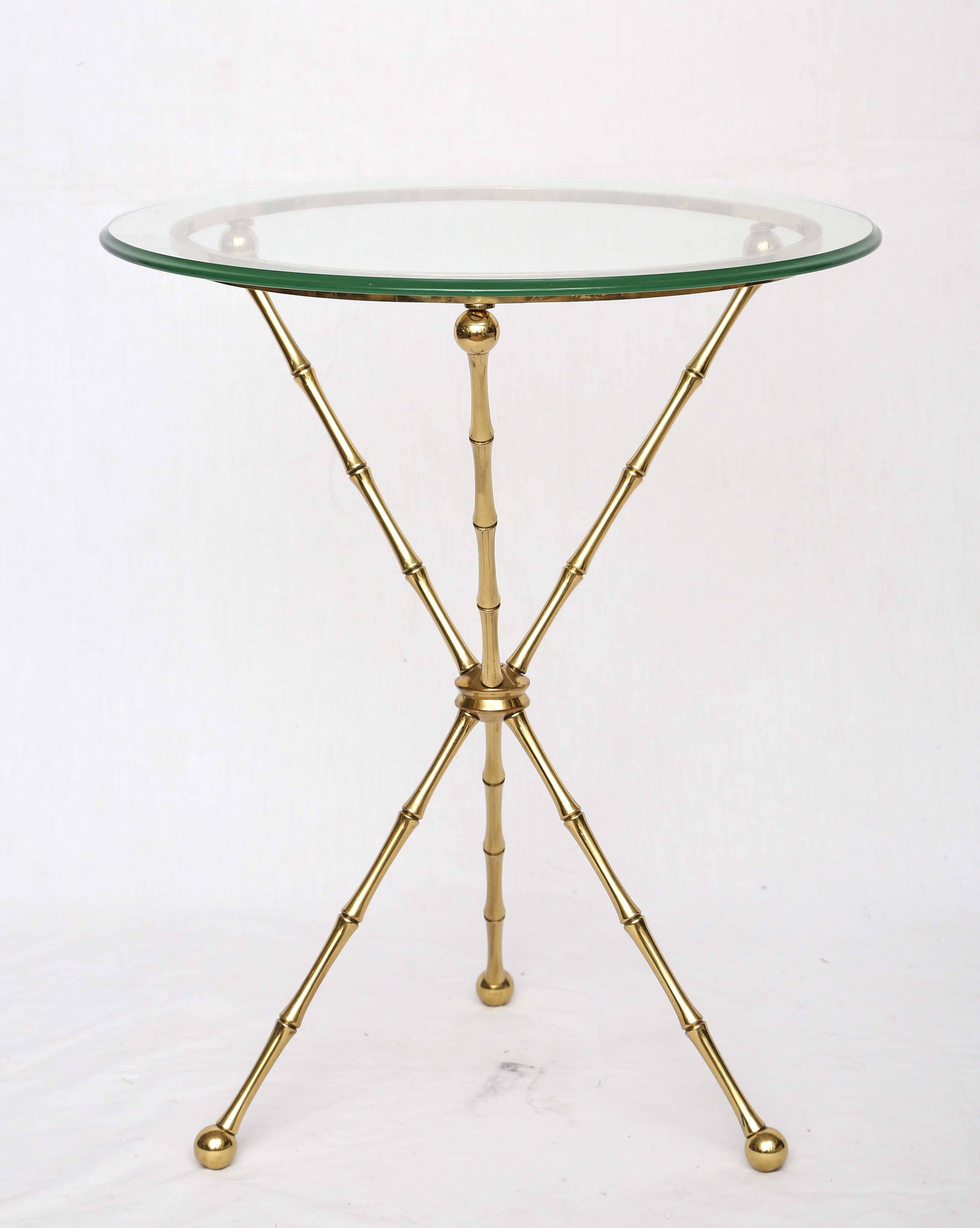 Offered is a Gio Ponti style side table with a three-legged brass base.
It comes with a round glass top.
  