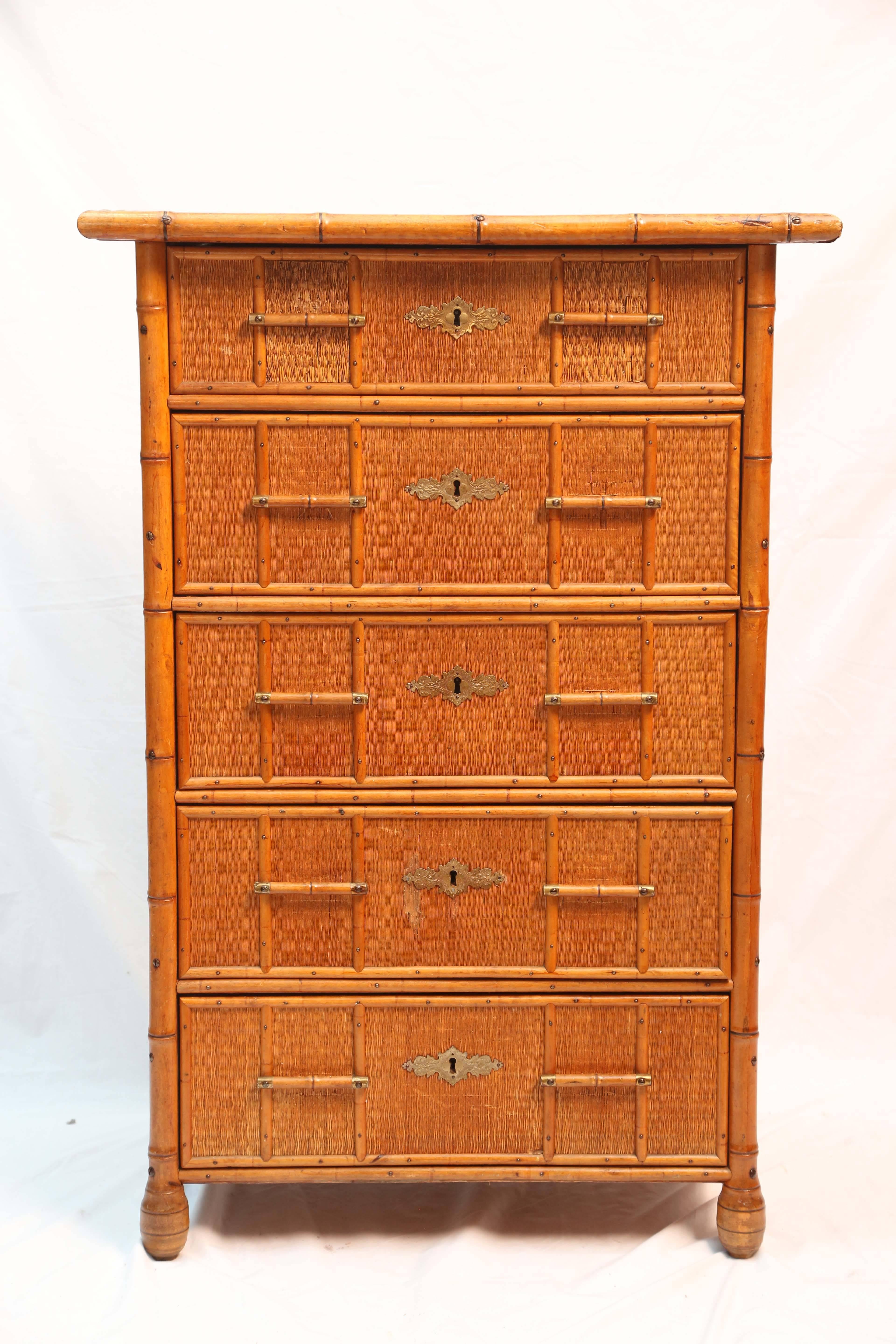 The unusual chest is appointed with root feet and tailored bamboo drawer pulls with brass appointments.