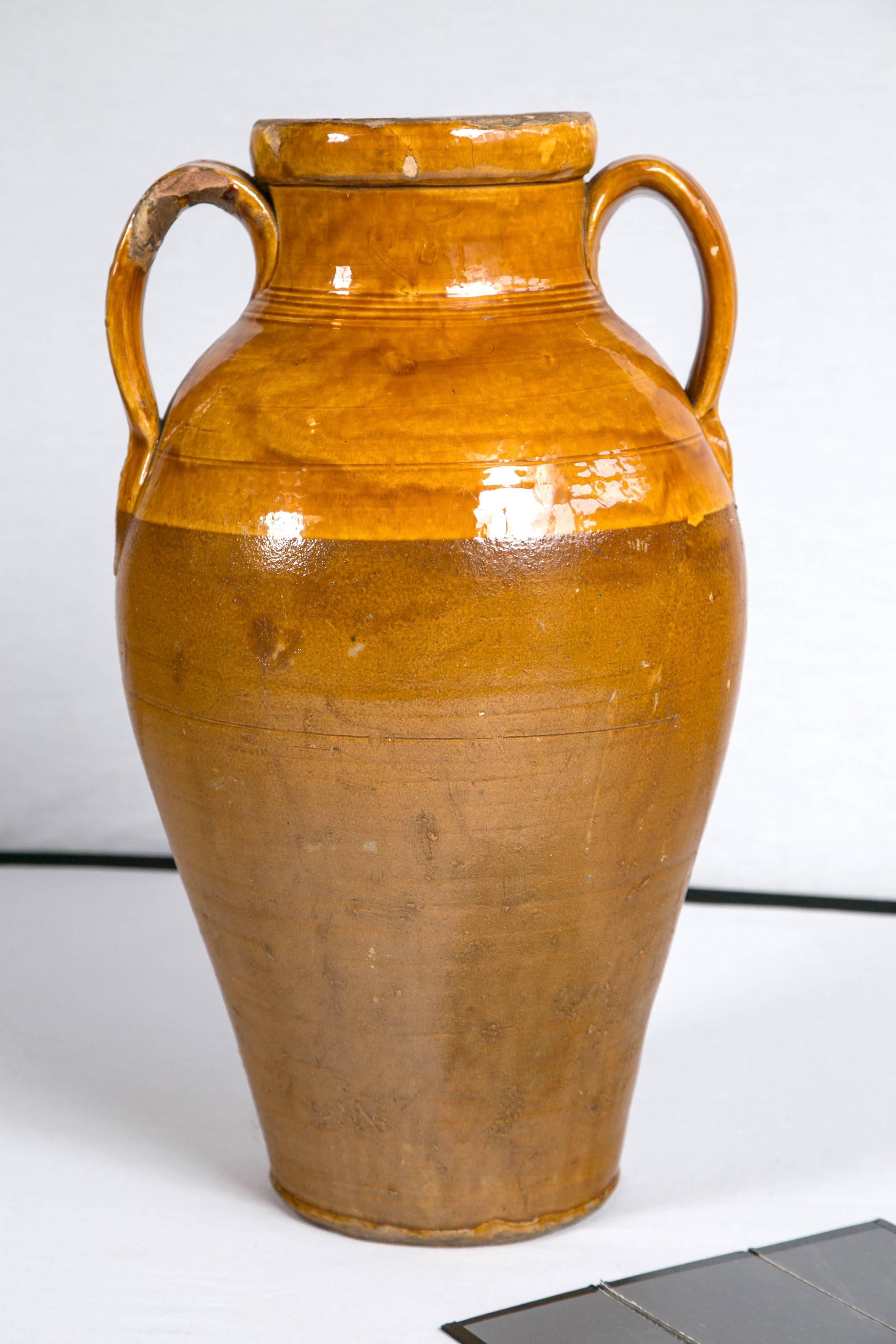 Vintage terracotta garden urn, Italy. Amphora shaped urn with deep yellow to umber glazing.