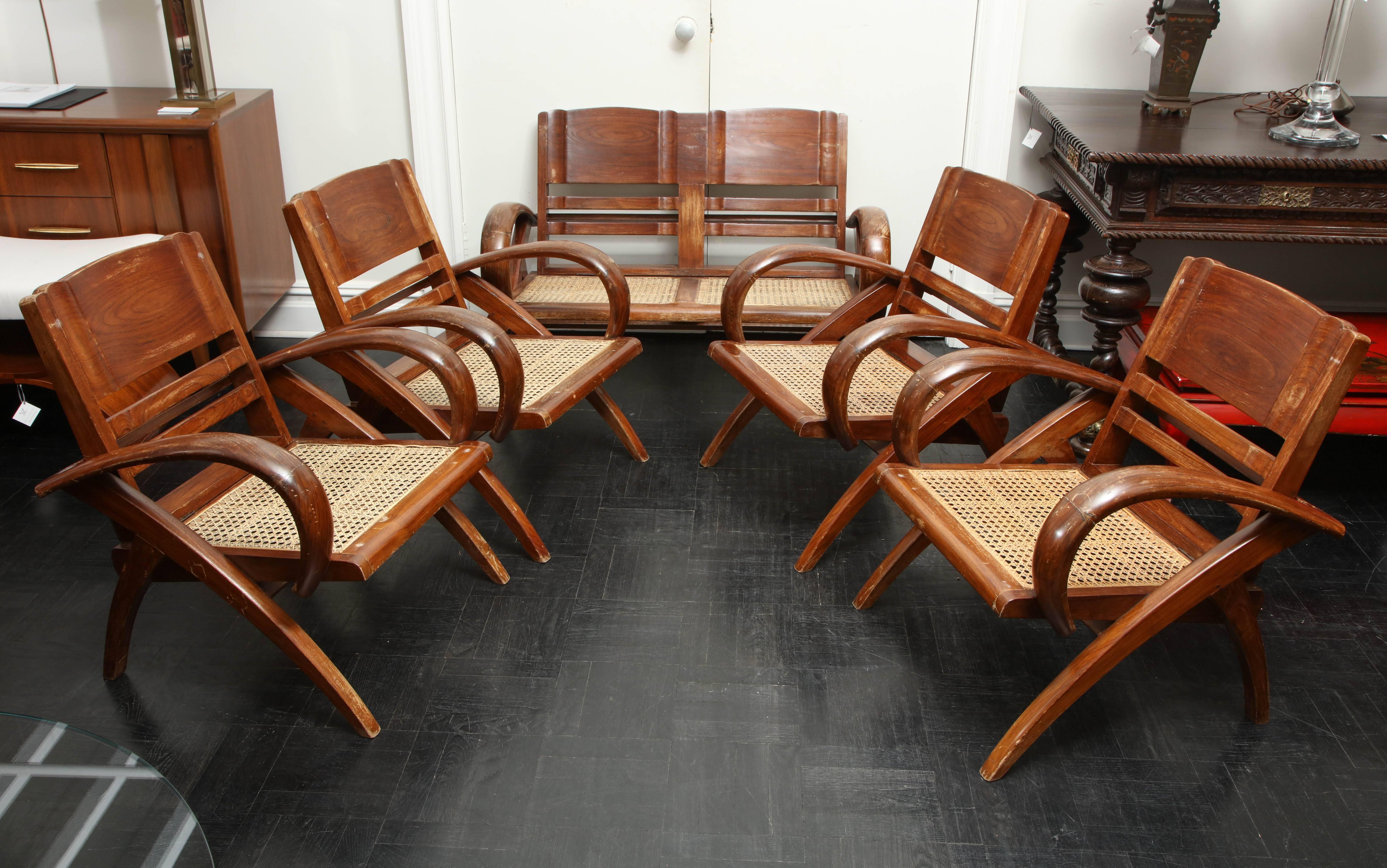 Set of four 20th century polished folding hardwood Colonial style armchairs with caned seats, one settee en suite Settee. Measures: 29