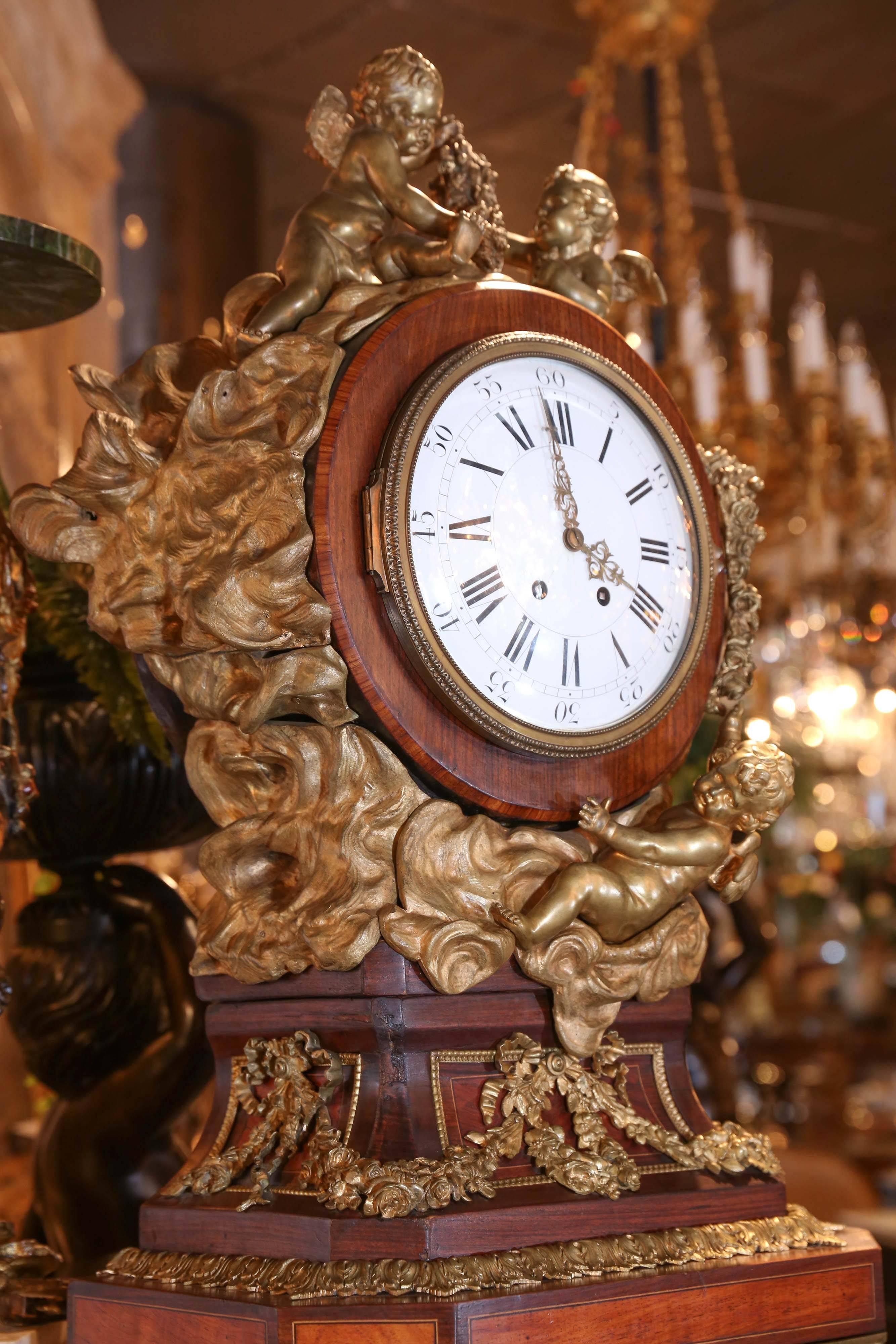 A rare and superb longcase clock from Paris after a model made by Riesner.
Heavily decorated with elaborate bronze cherub and putti mounts.
Kingwood and rosewood case with marquetry inlay. the model made by
Riesner is in the Louvre. A photo of