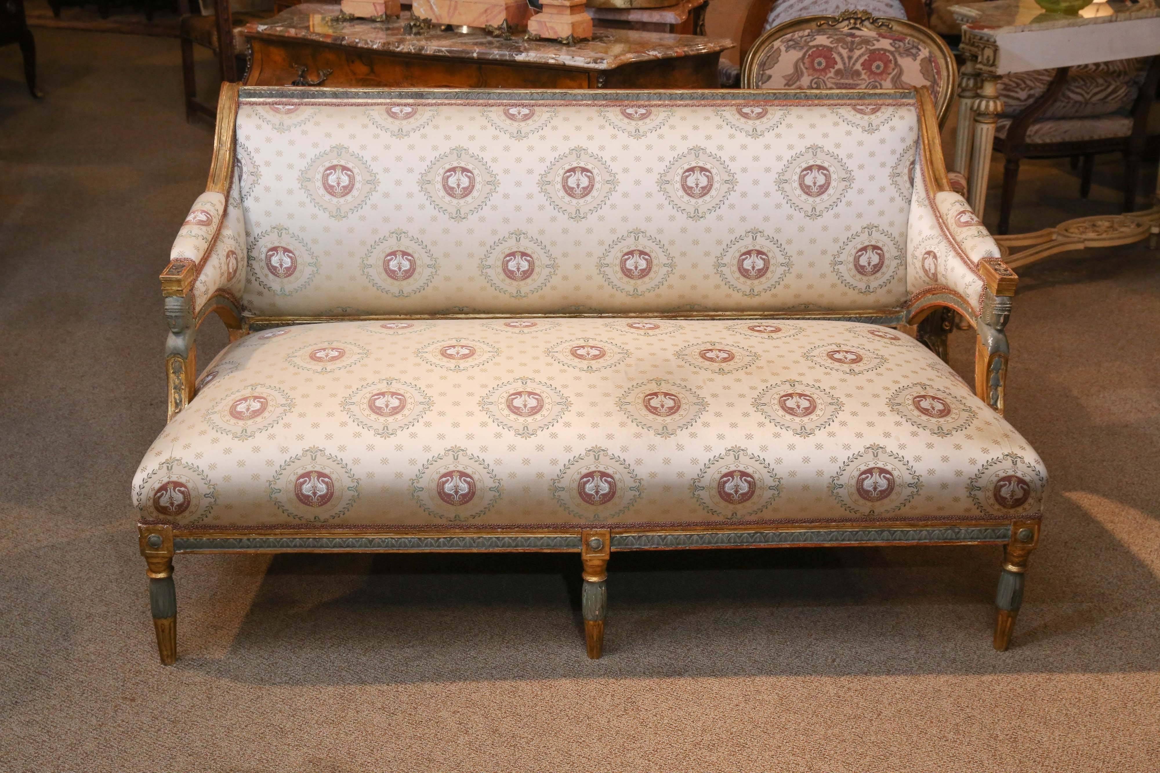 Exceptional French Empire settee pale celadon green paint and giltwood
frame, figural Egyptian heads carved on the arms. Reeded French
legs in paint and giltwood combination.
   
