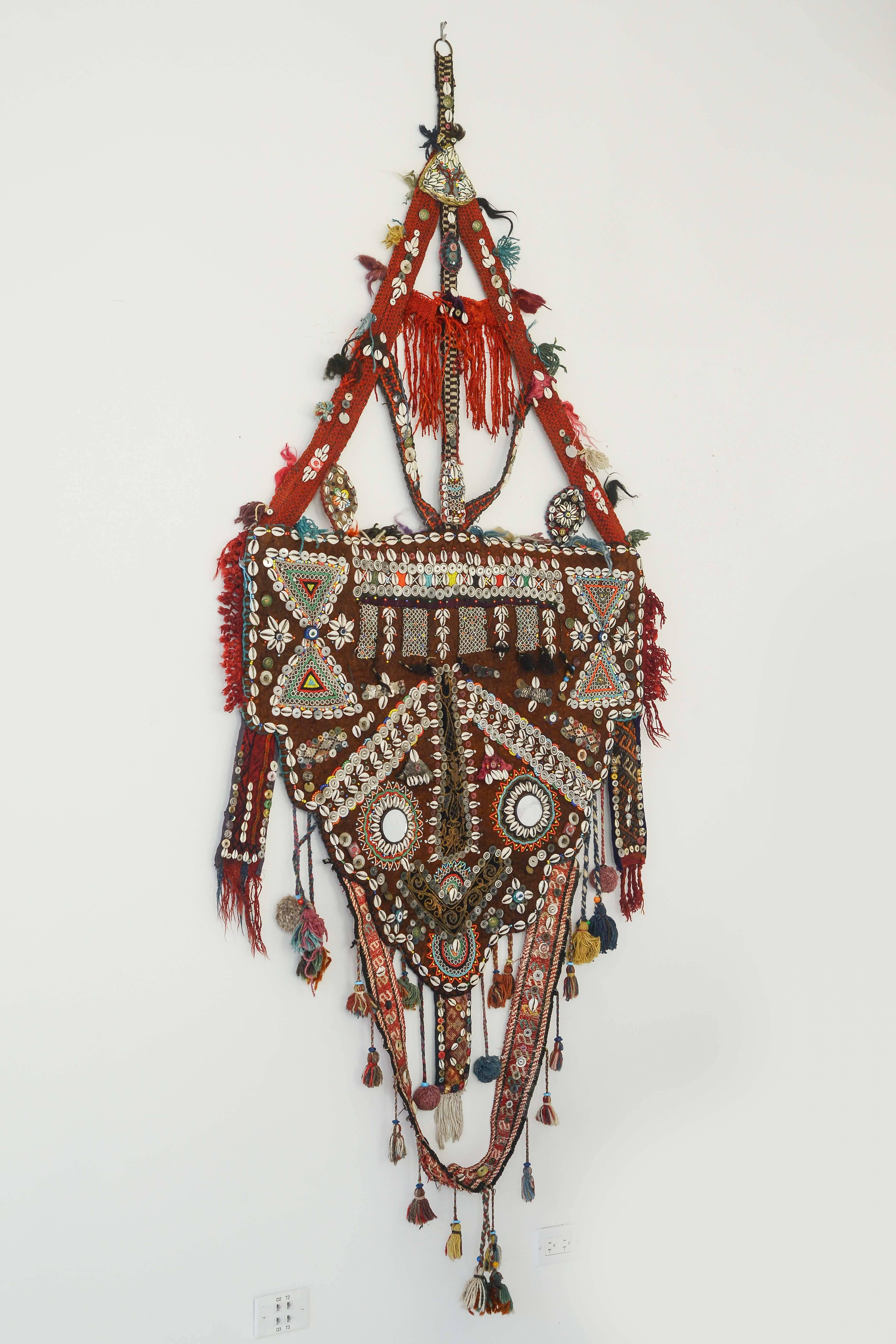 This highly decorative and embellished camel harness from India is amazing as a work of art! The level of detail and wow factor will add a three dimensional piece of art to any space hard to find.
