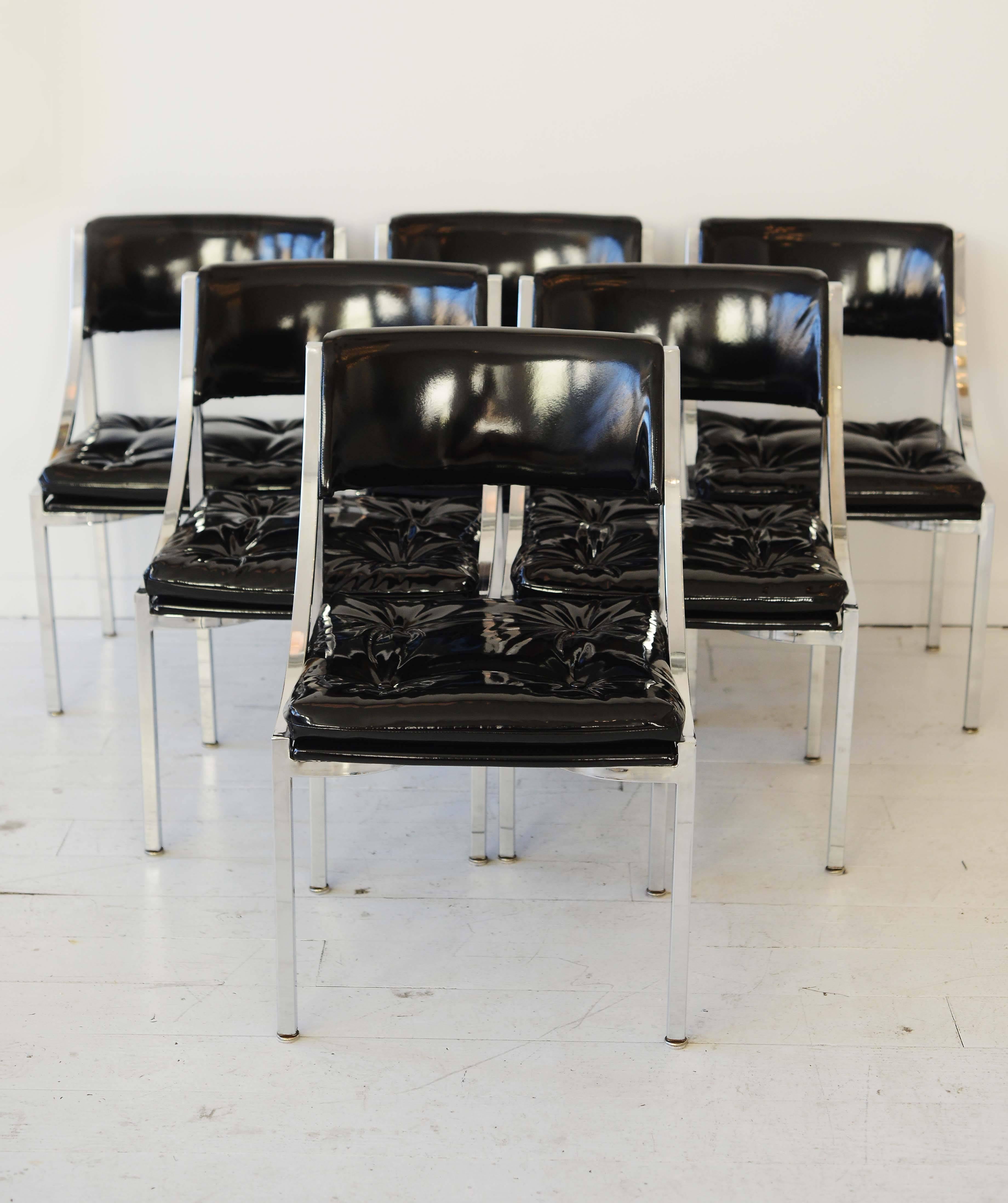 This set of six Mid-Century chairs have recently been reupholstered in the finest black patent leather fabric. Heavenly to see and heavenly to lounge in.