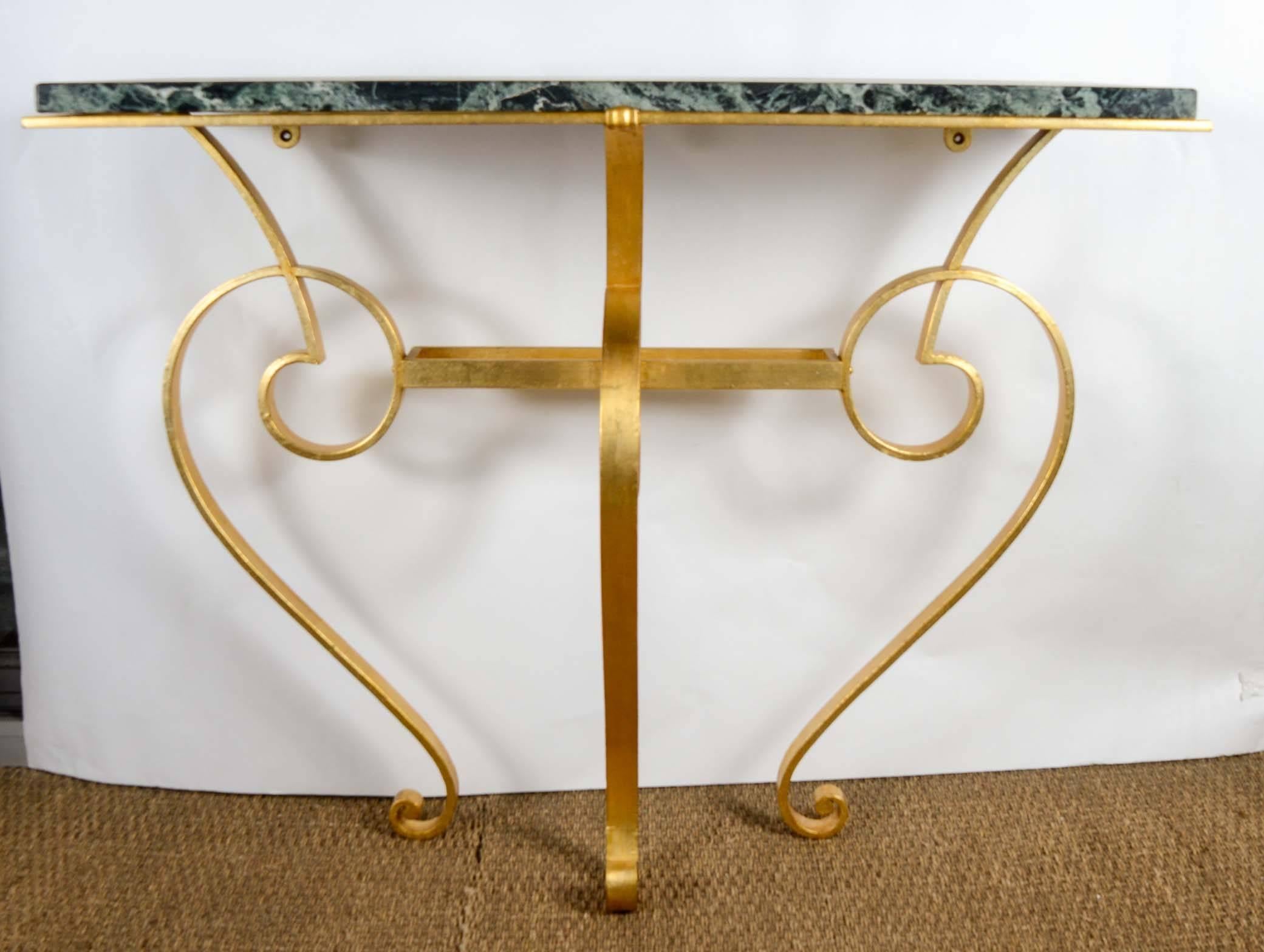 Console table in golded wrought iron with top in green marble.