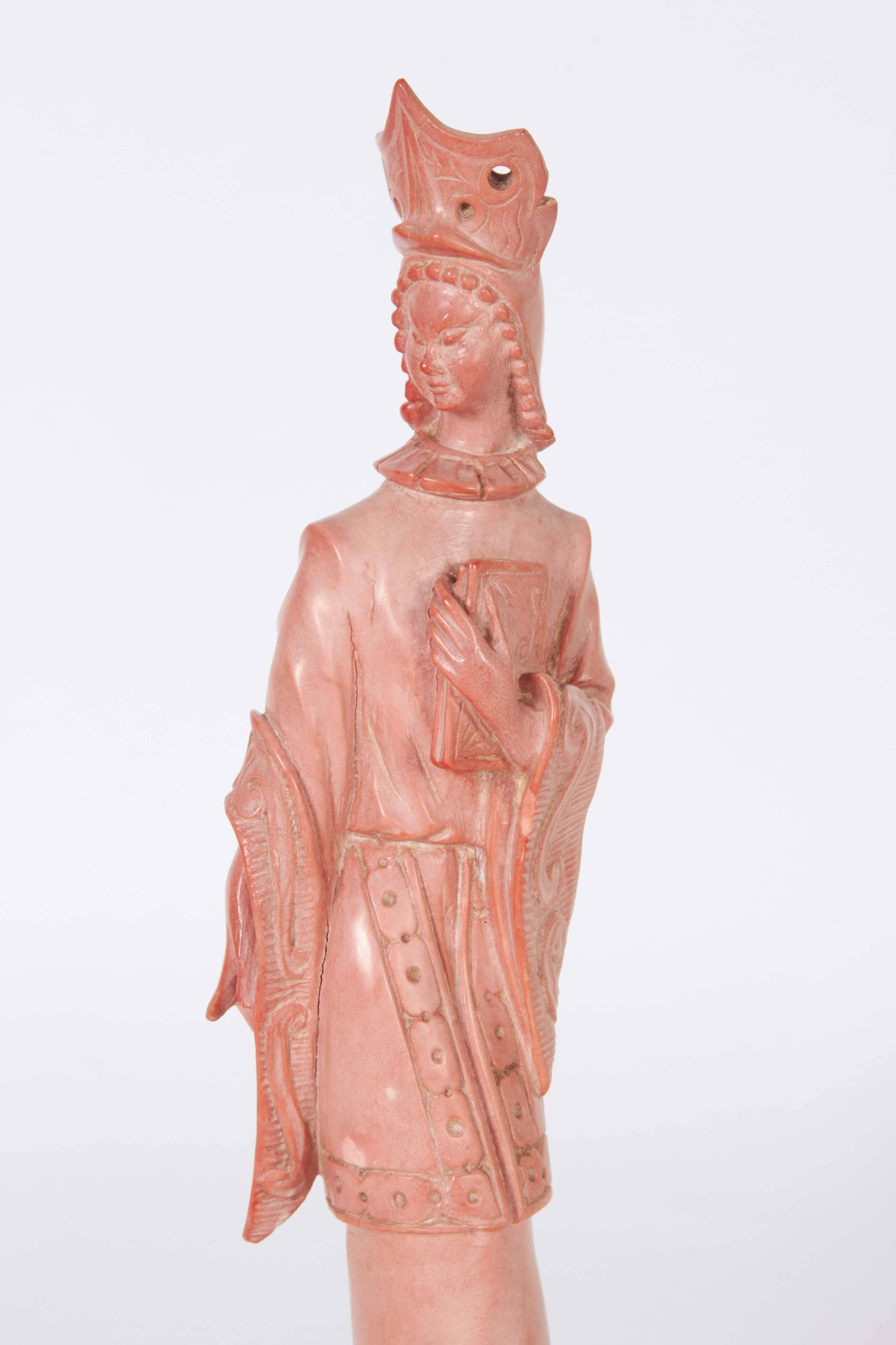 A sculpture carved from pink composite stone, depicting bodhisattva Guanyin, Goddess of compassion, mounted on black base. Very good condition, wear consistent with age and use.