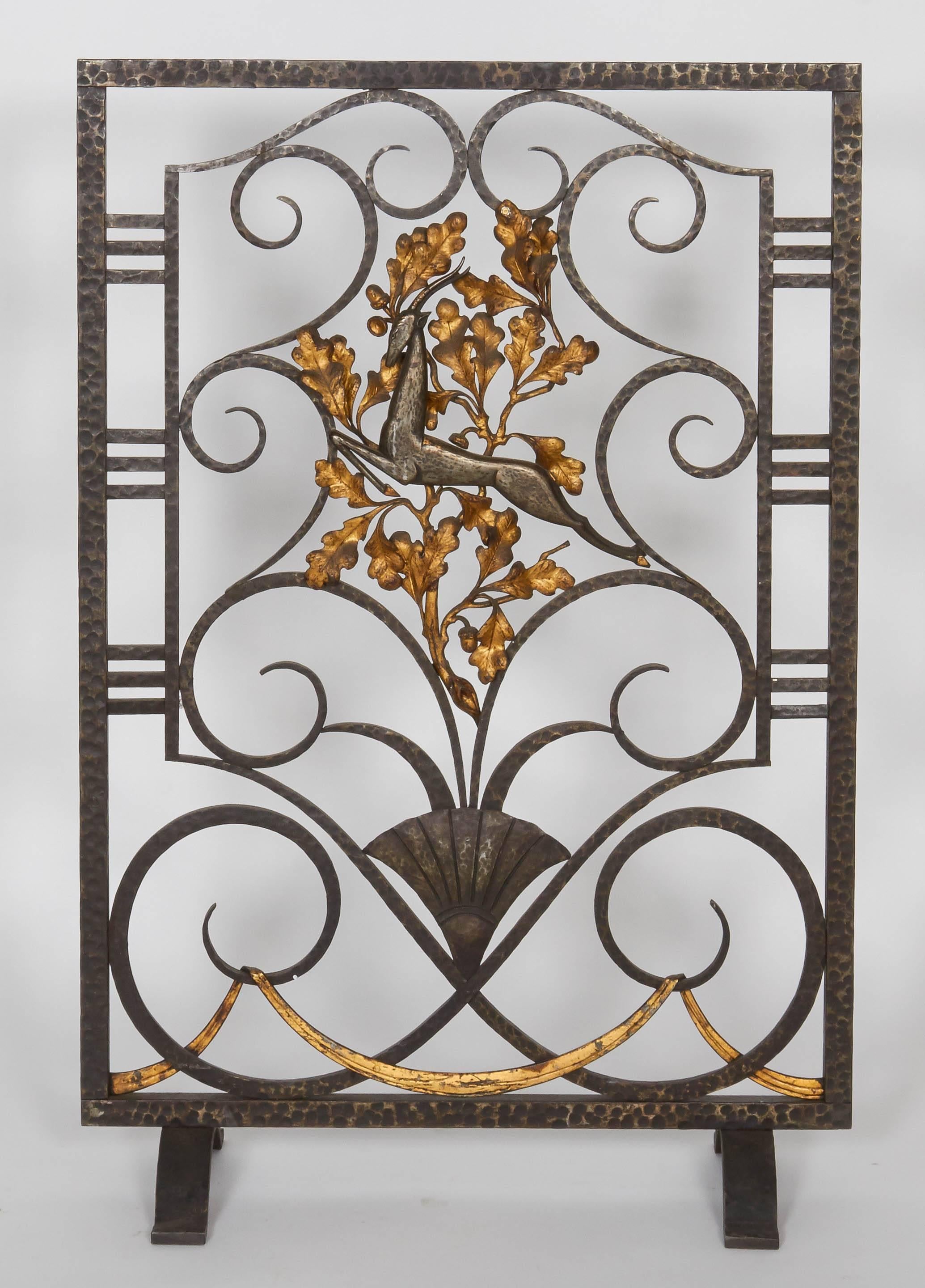 Wrought iron fire screen by Edgar Brandt.
Black patina with gilded accents.
Measures: Height: 32