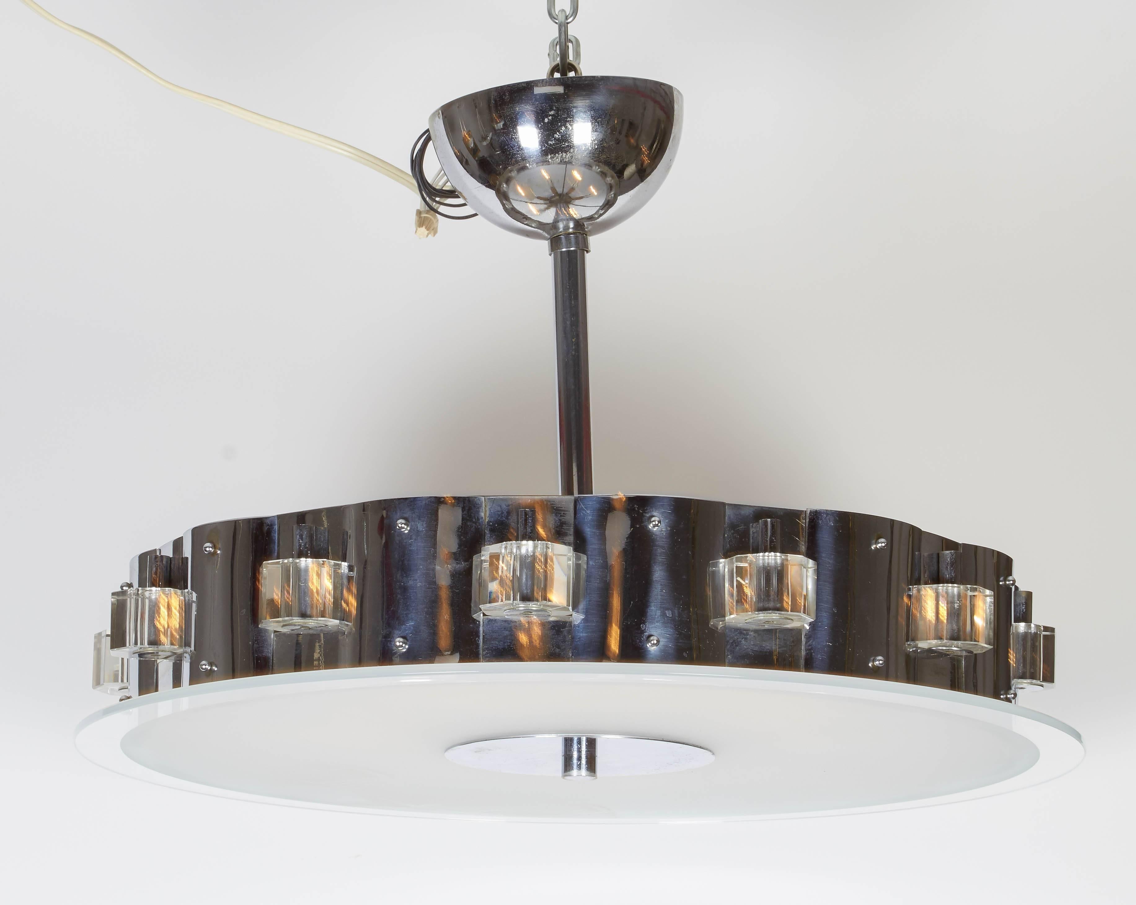 Art Deco chandelier, made of nickel-plated brass decorated with cut-glass inserts, and a clear and frosted bottom plate.
Measures: Height 18