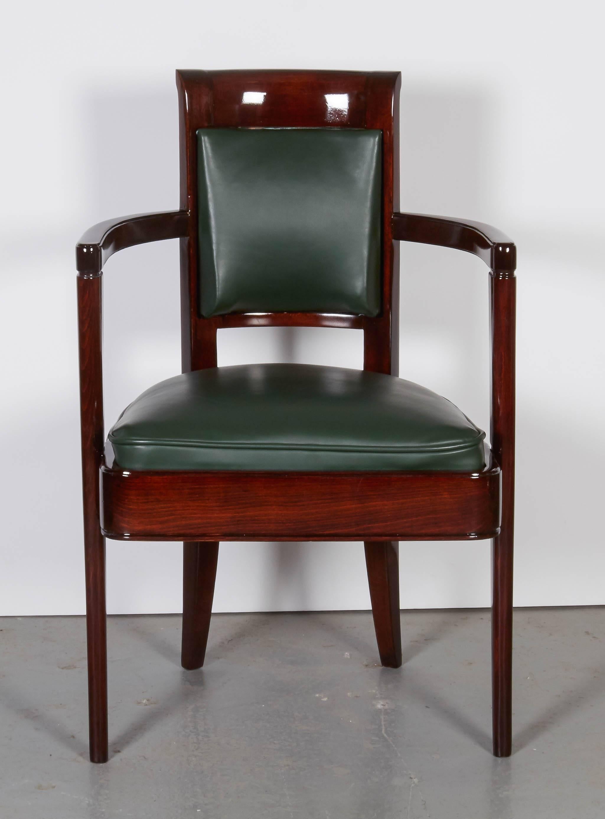 Three Pierre Patou armchairs,
colored oak wood and green leather, refinished.
Measures: Height 34.5",
width: 22",
depth: 20".