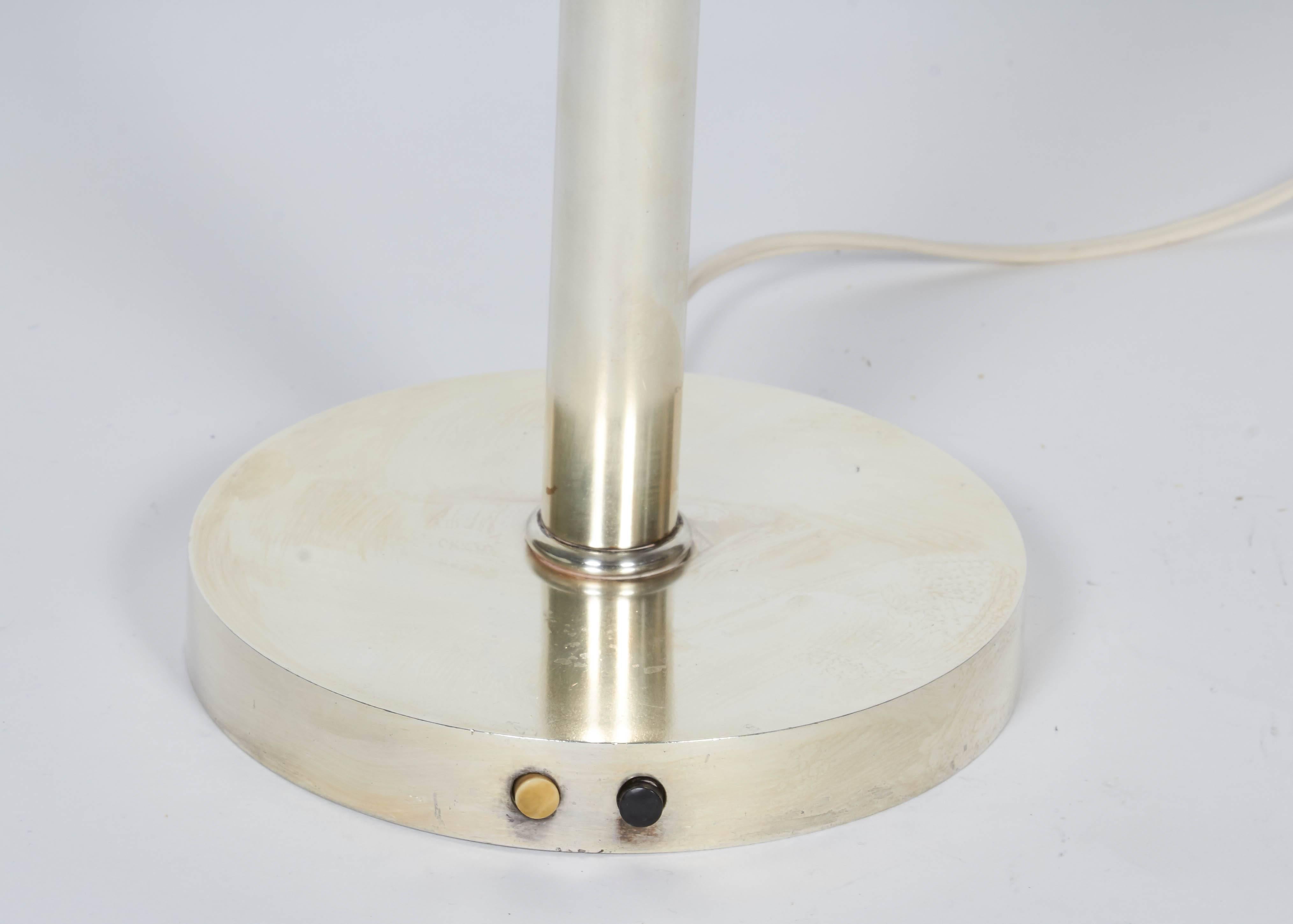 Nickel-plated brass and frosted glass table lamp.