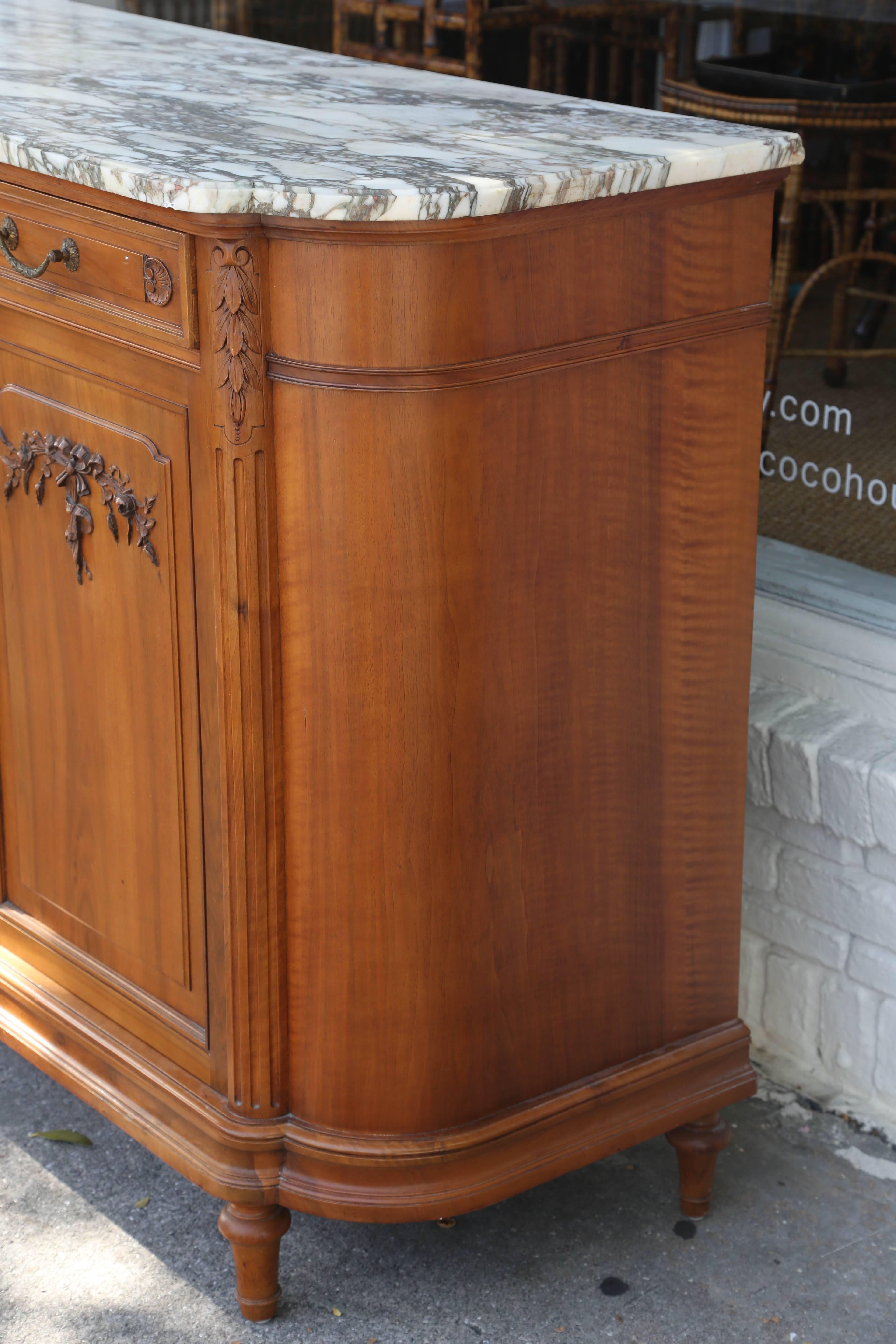 Superb French sideboard with ribbon and rosette garland motif, marble top, two side by side drawers over two cabinet doors, Very good condition.