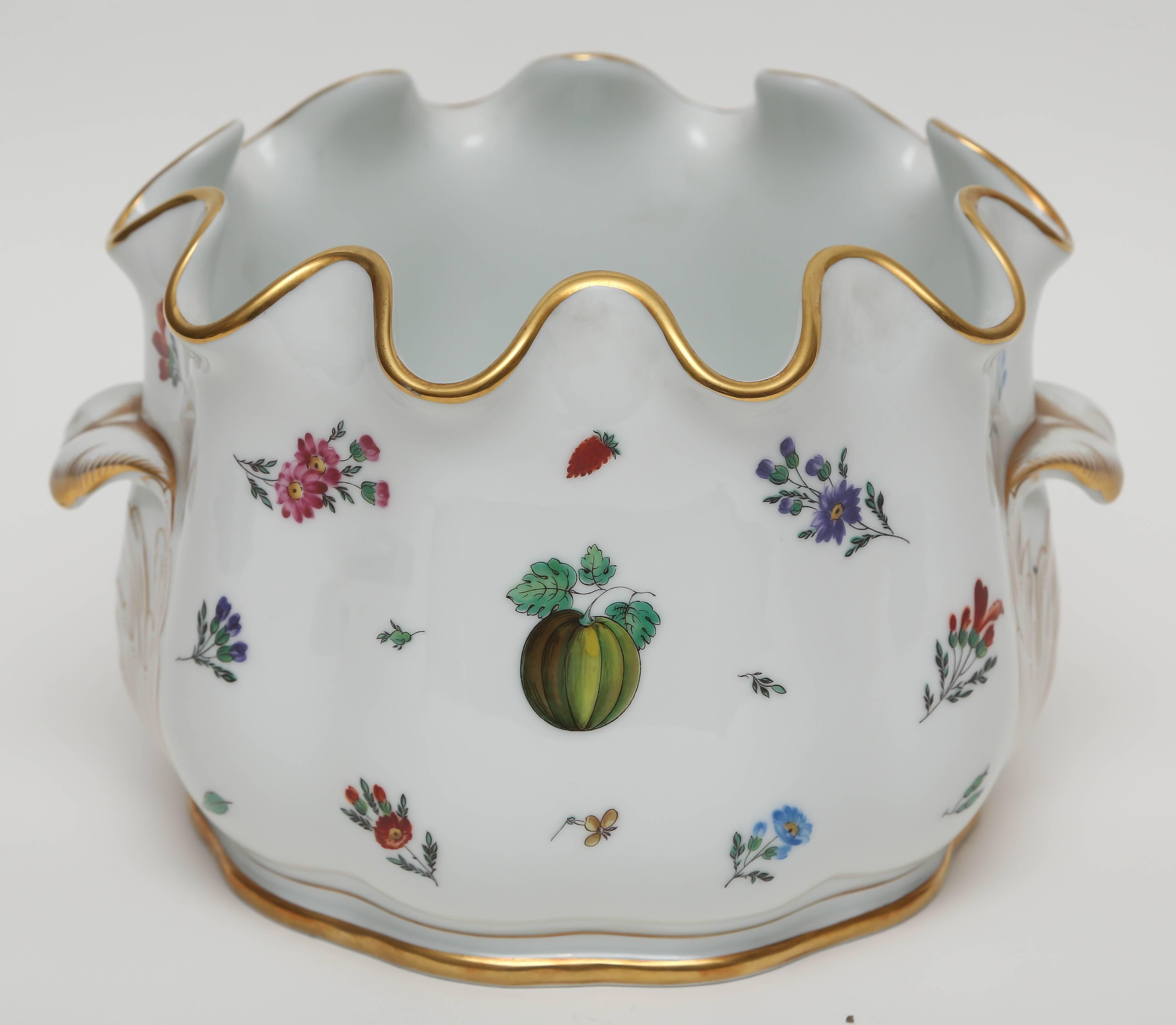 A fine bone china decorative and pretty piece by the re known Italian porcelain firm of Ginori. A nicely scalloped shape, hand-painted botanicals and 24-karat gilt trim highlight this piece. Impressive in size and could also be used for a