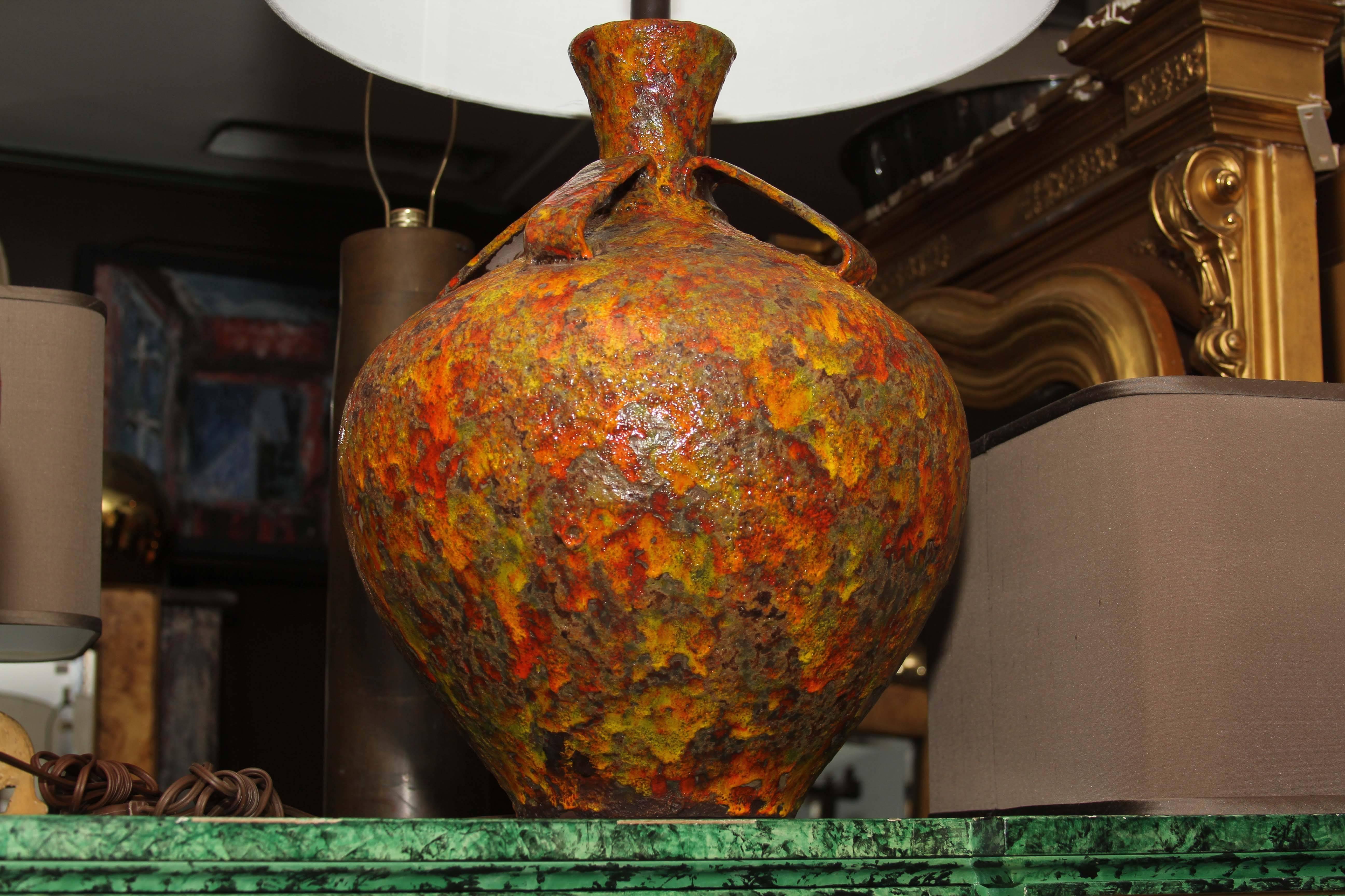 Large pottery lamp bases with thick glaze in yellows and orange.