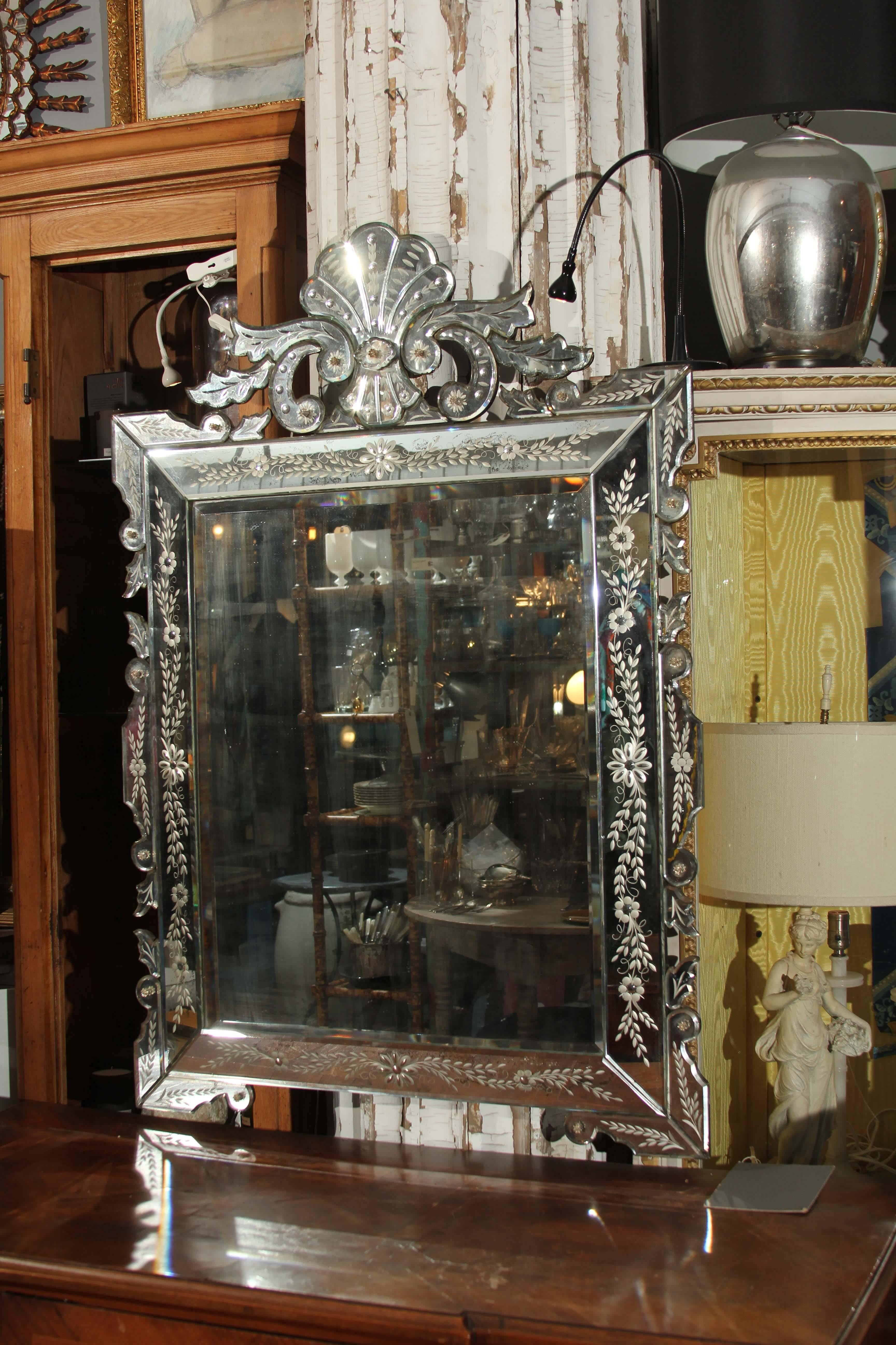 Rectangular Venetian mirror with shell and flourishes on crown.