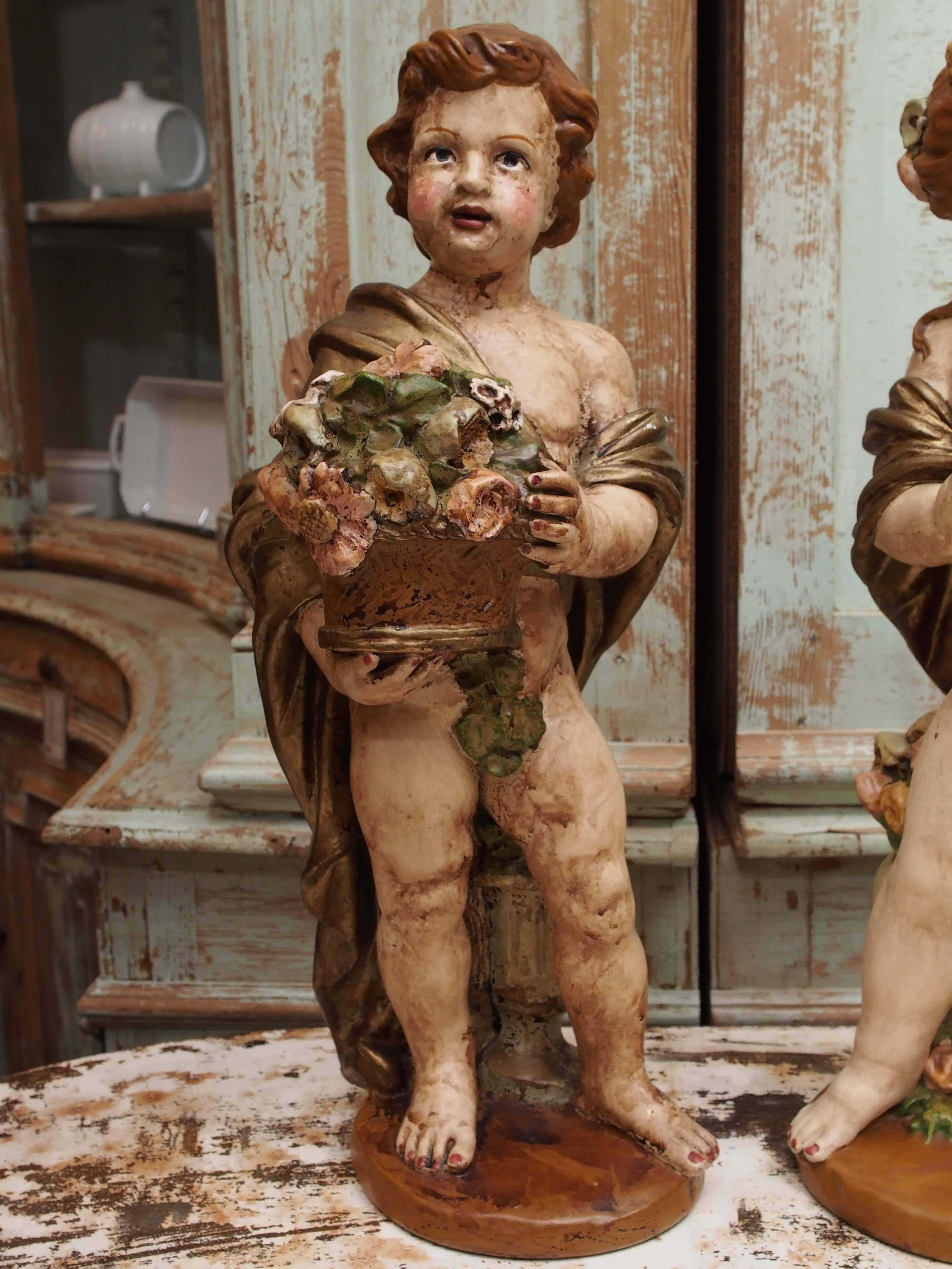 Pair of early 19th century French painted resin statues depicting a whimsical boy and girl.