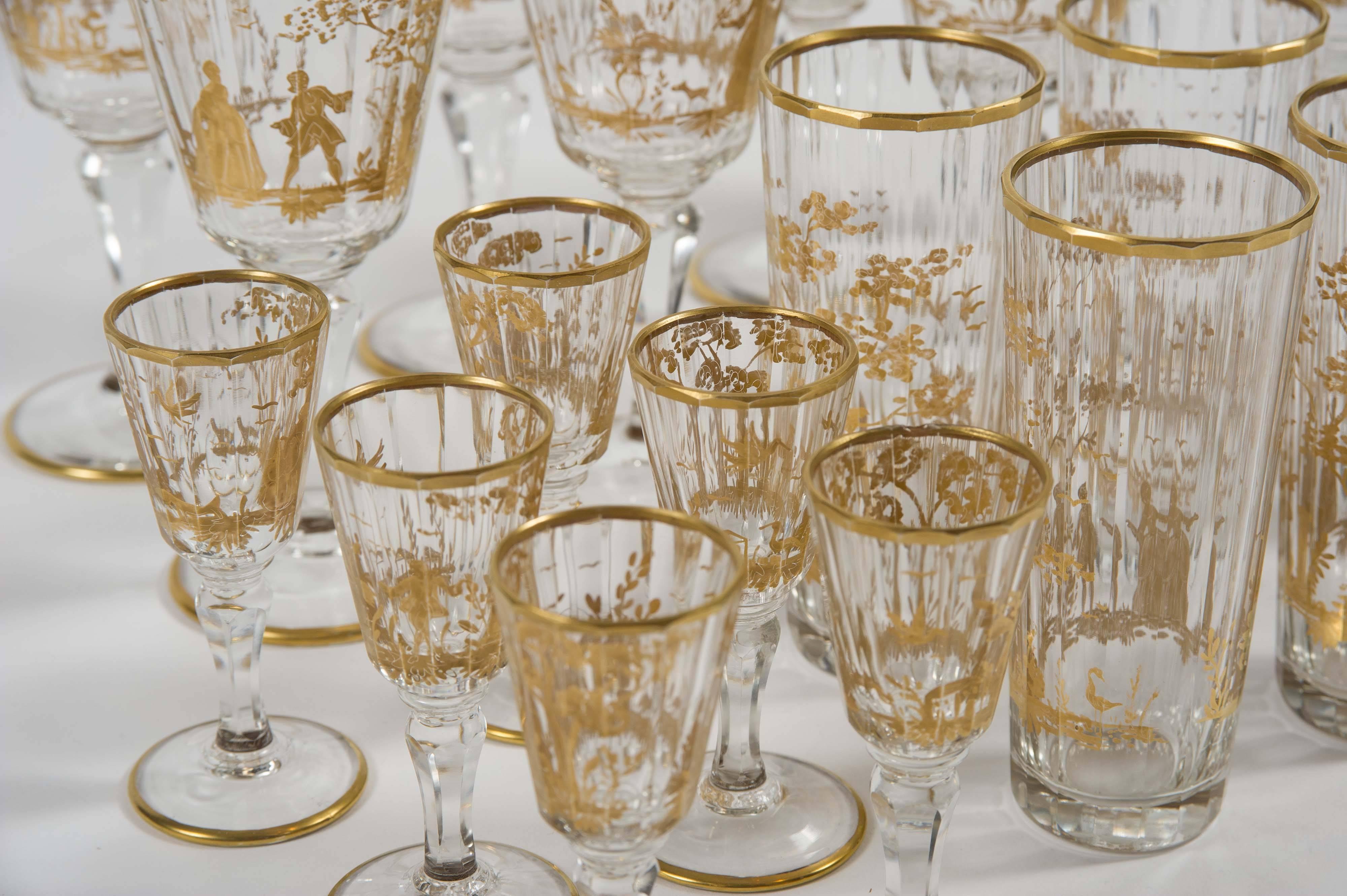 The set comprising eight wine glasses, eight water glasses and six liquor glasses.
All with extremely fine hand-painted gilt decoration. Each glass with a unique scene depicting a lady and gentleman in 18th century dress in a woodland.
Wine