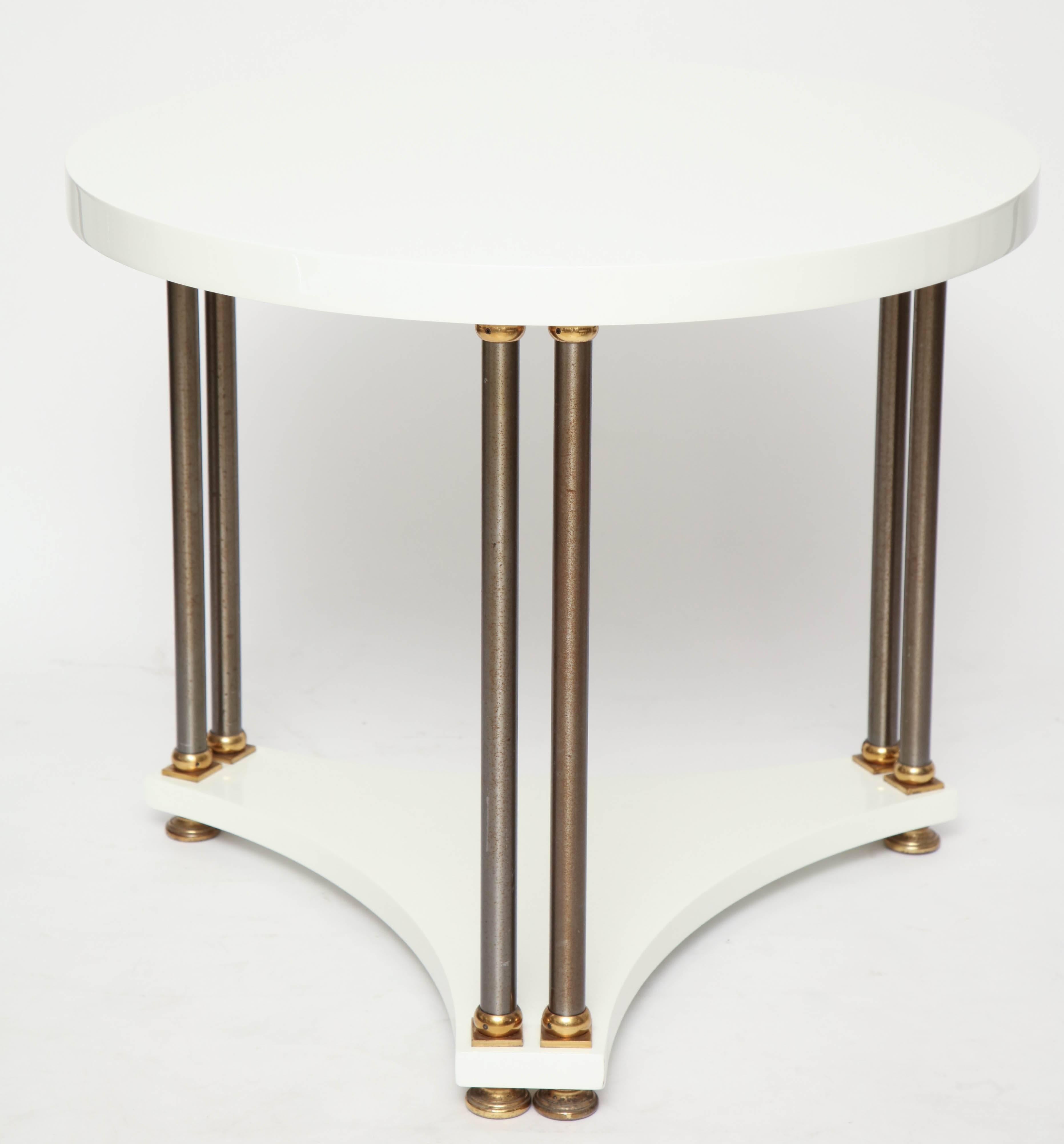 Round white lacquer table with brass legs, in the spirit of Maison Jansen.