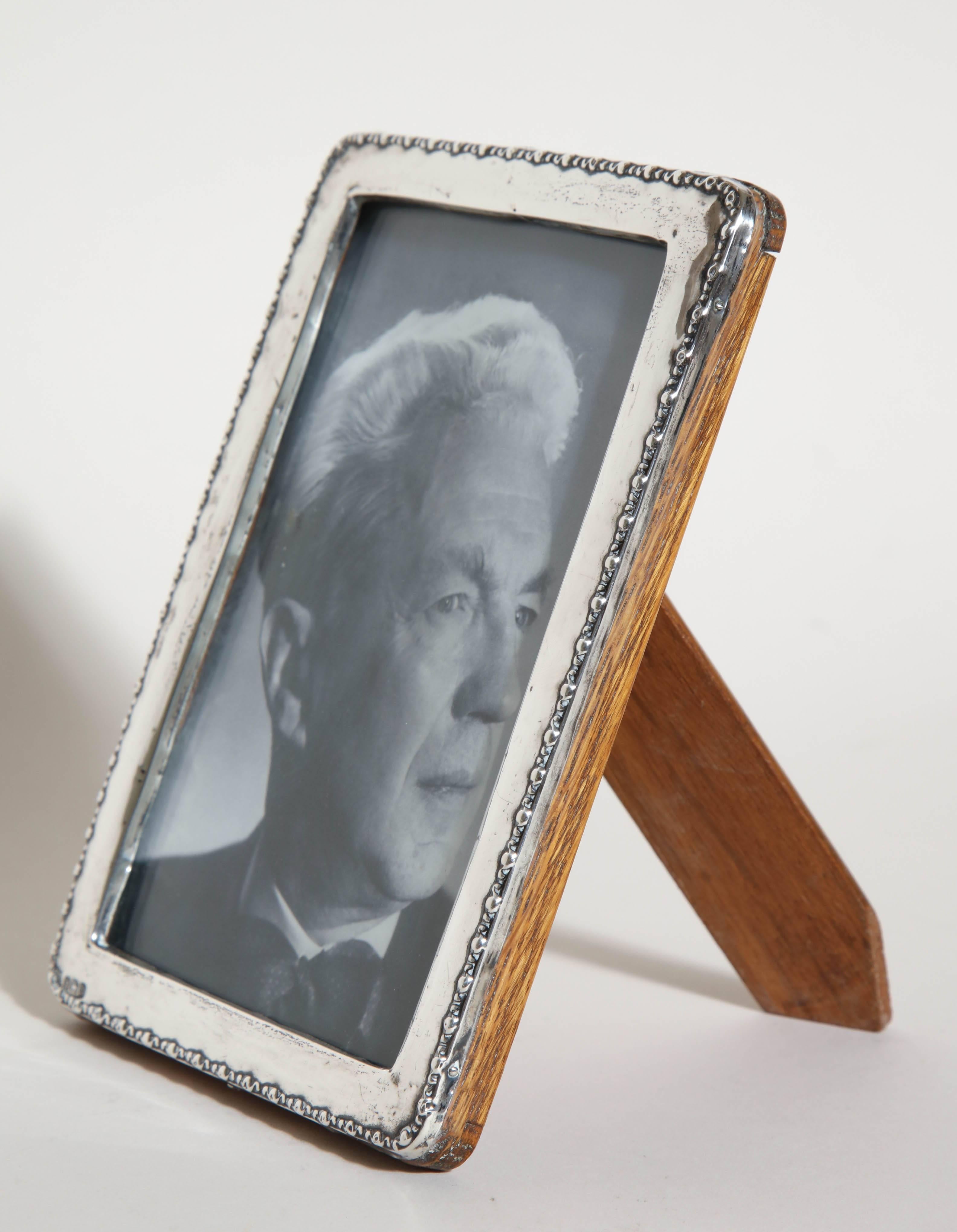 Sterling silver photograph frame with beaded border and with original oak back and stand. (Photo of Jules Leleu)

Impressed for 925 silver/ Birmingham/ 1922/ W J M & Co.