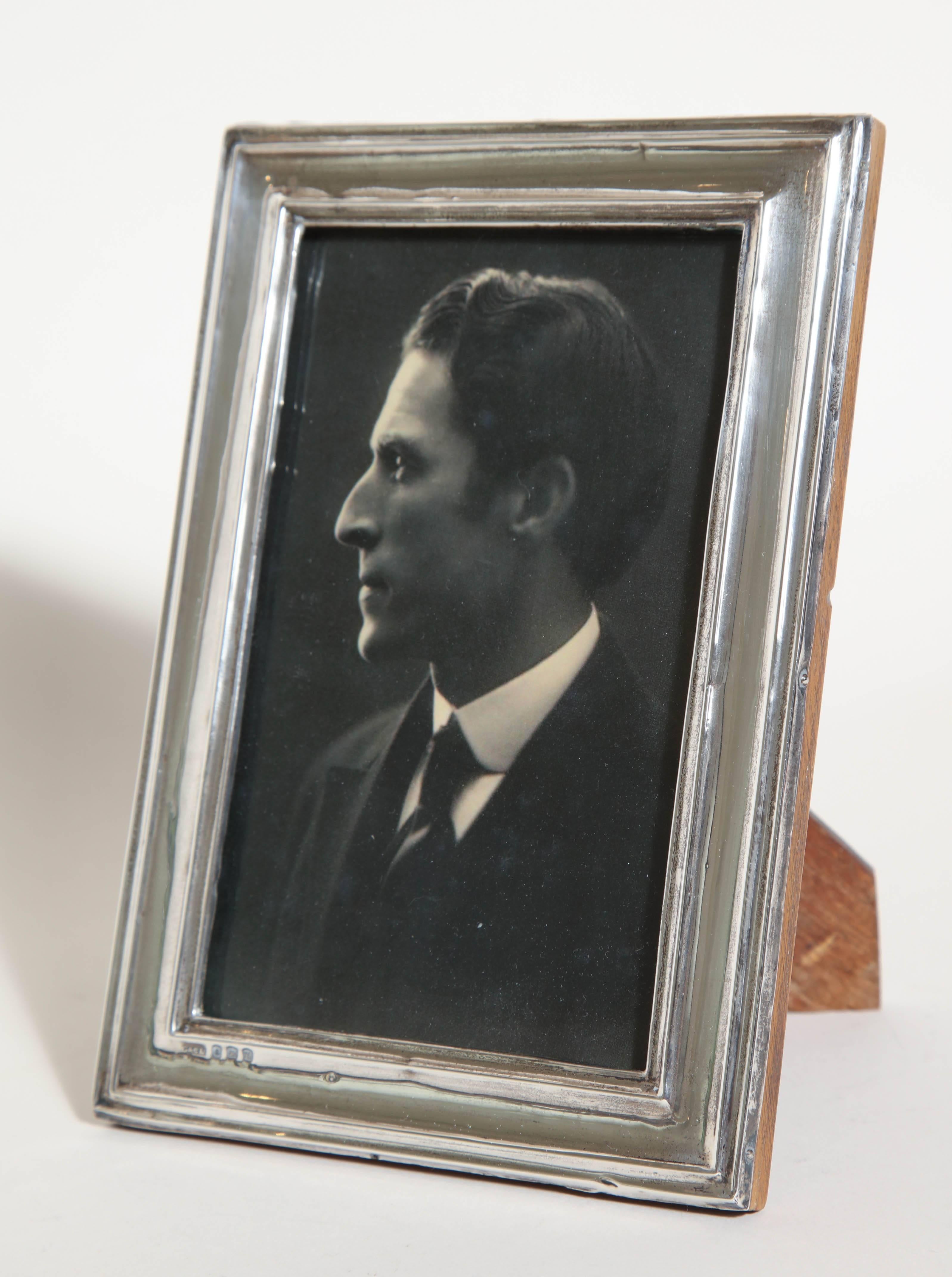 Sterling silver photograph frame with indented inner and outer border with original oak back and stand. (Photograph of Paul Follot)

Impressed for 925 silver, Birmingham, 1919, G & C Ltd.