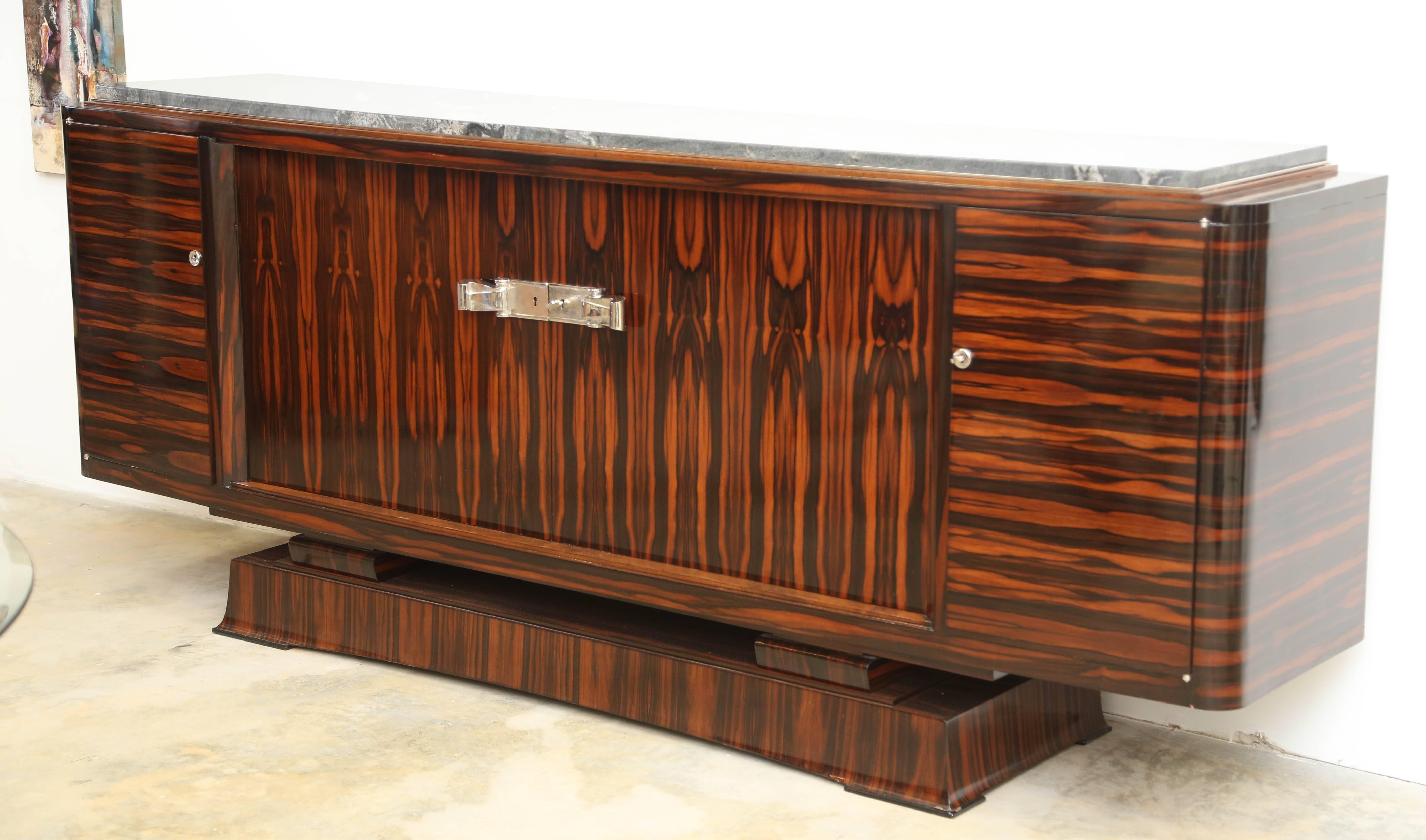 Magnificent design, superb craftsmanship in Macassar wood for this Sideboard by Pance & Rouget. shelves and a set of drawers in the middle inside of the piece. This piece is a French Art Deco furniture, carefully refinished , excellent condition