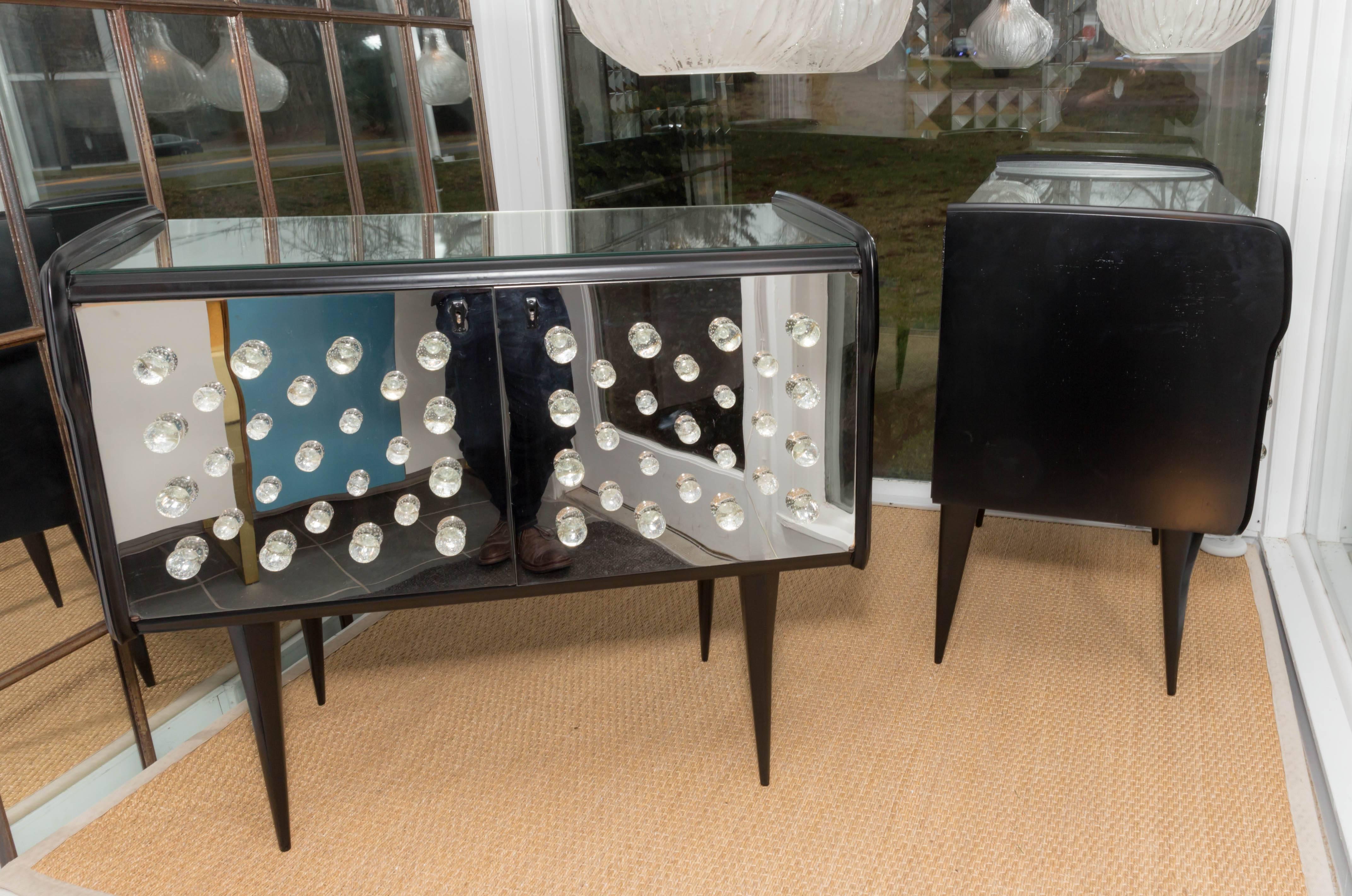 Mid-Century Modern Pair of Ebonized Wood Chests Featuring Doors with Glass Ball Motif