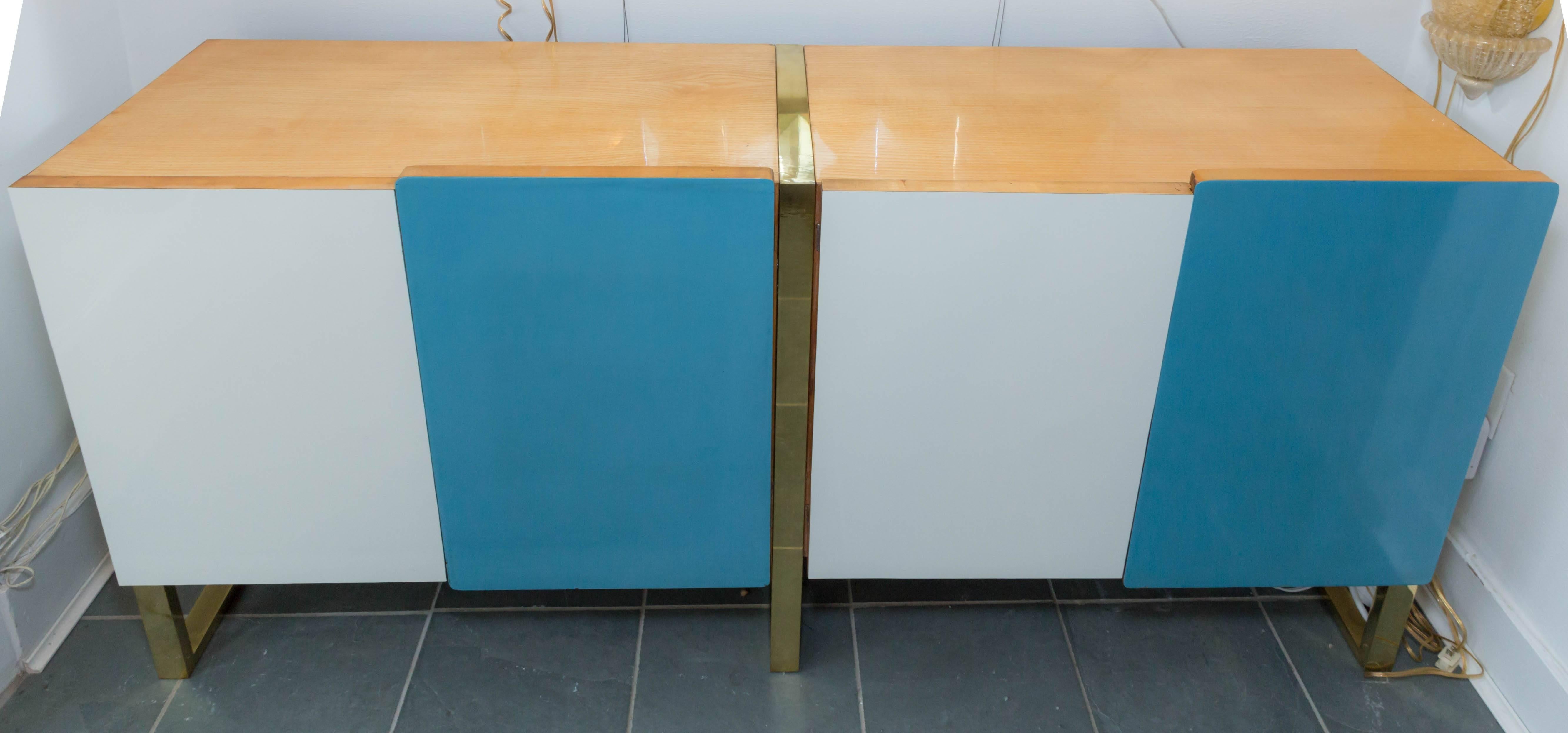 Light wood cabinet with blue and white front door and brass detail in the style of Gio Ponti.